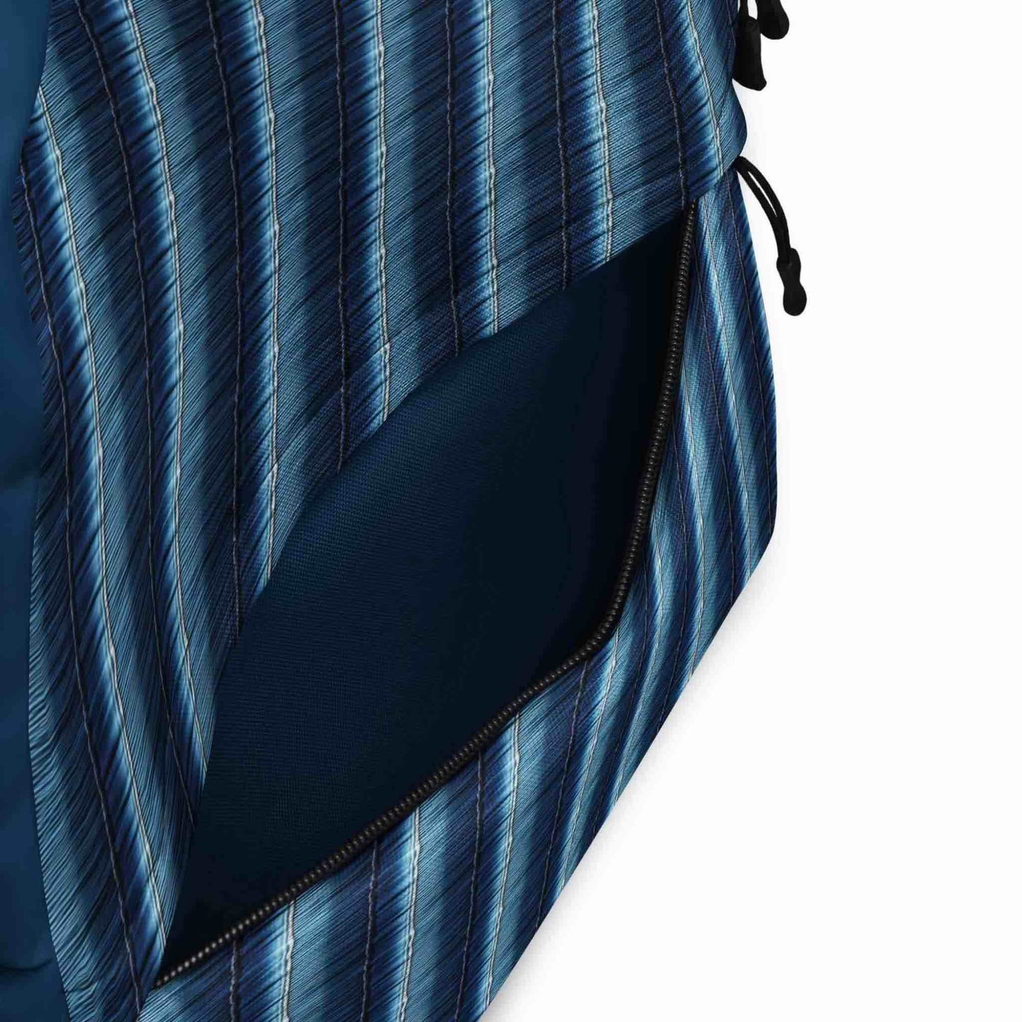 Inside pocket in front of backpack, in solid blue fabric, shown.