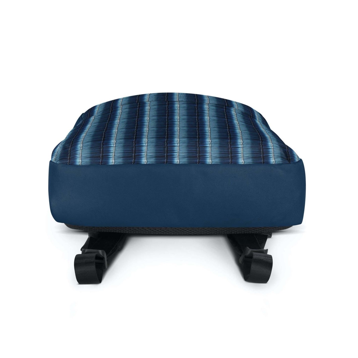 The bottom of the backpack with its solid dark blue fabric.