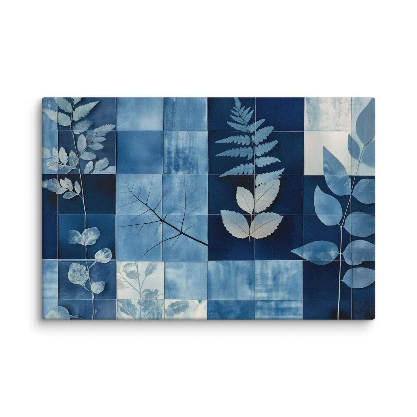 Discover PHOTOTYPE, a serene yet striking large landscape canvas print featuring a botanical cyanotype collage. Intricate white leaf silhouettes dance against rich indigo and navy blues in a modern grid design. Experience the beauty of nature and scientific artistry. Perfect for adding a touch of sophisticated calm to any space. This canvas print has a vivid, fade-resistant print that you're bound to fall in love with. 20x30 inch dimensio. Landscapre orientation. White background.