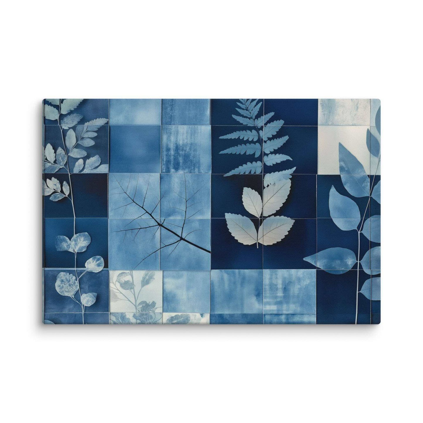 Discover PHOTOTYPE, a serene yet striking large landscape canvas print featuring a botanical cyanotype collage. Intricate white leaf silhouettes dance against rich indigo and navy blues in a modern grid design. Experience the beauty of nature and scientific artistry. Perfect for adding a touch of sophisticated calm to any space. This canvas print has a vivid, fade-resistant print that you're bound to fall in love with. 24x36 inch dimensio. Landscapre orientation. White background.