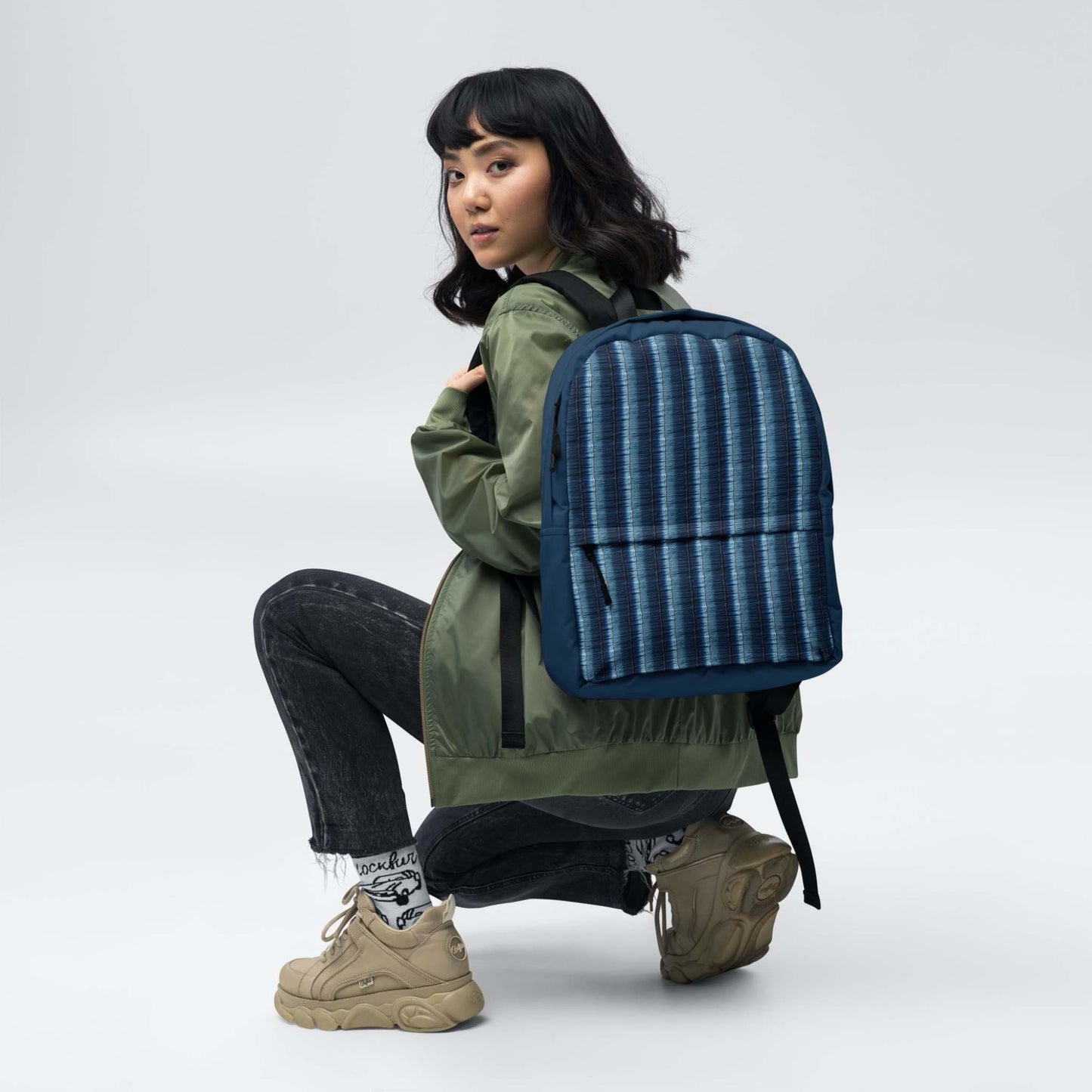 Printed backpack featuring denim stripes on the back of a girl.