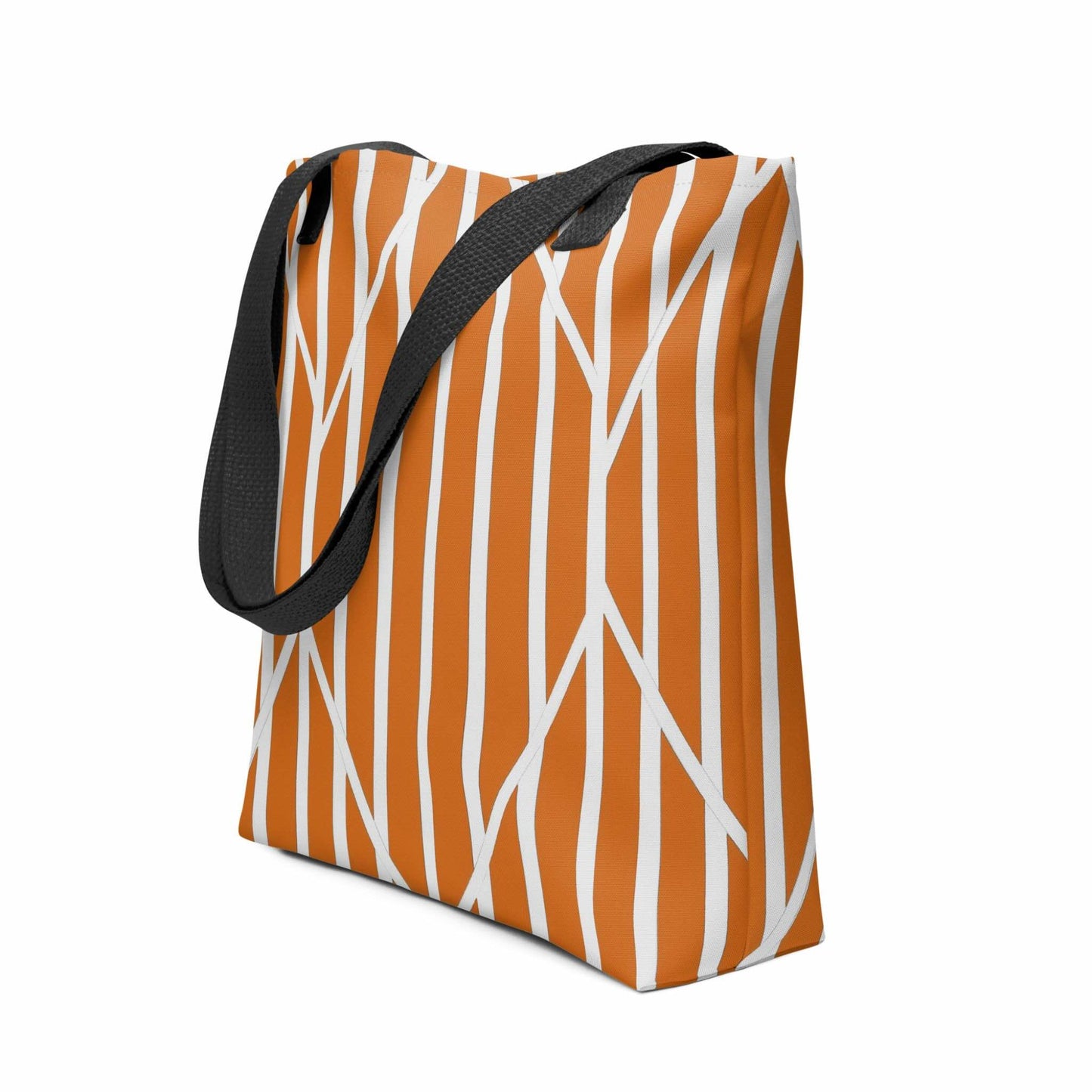 The design of this burnt orange tote features a compelling dance between the rich, autumnal stripes and the sharp, white geometric overlay. This sophisticated interplay creates a dynamic, warm visual tension. Dimensions 15x15 inches. Side view. White background.