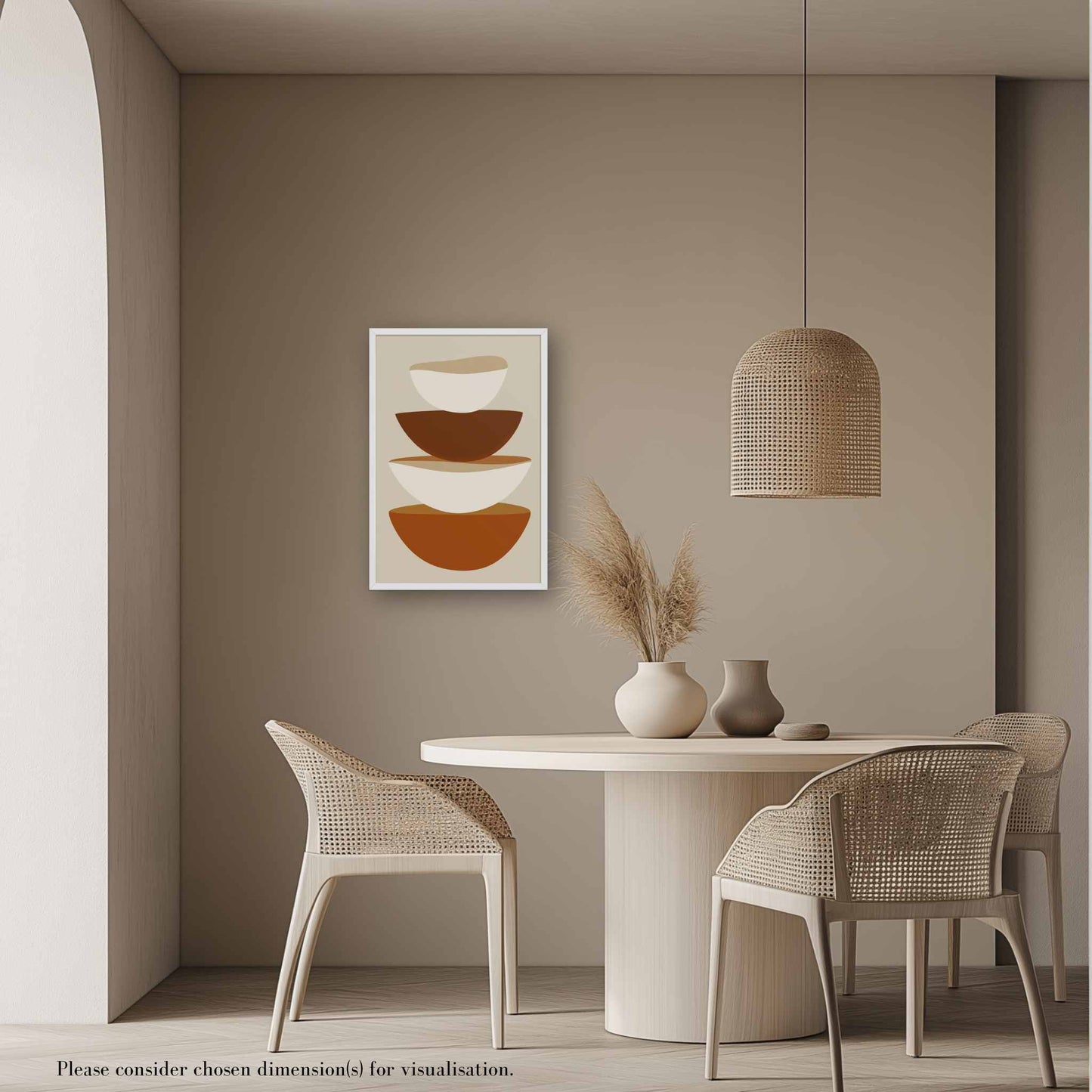 A minimalist abstract art form in framed poster, featuring stacked bowls in warm earthy tones on soft biege, its clean, contemporary, and slightly rustic aesthetic adds a touch of calm sophistication to your kitchen or dining area. Framed in wood in white color. The poster hangs on a biege wall near a dining table in a contempoary rustic setting.