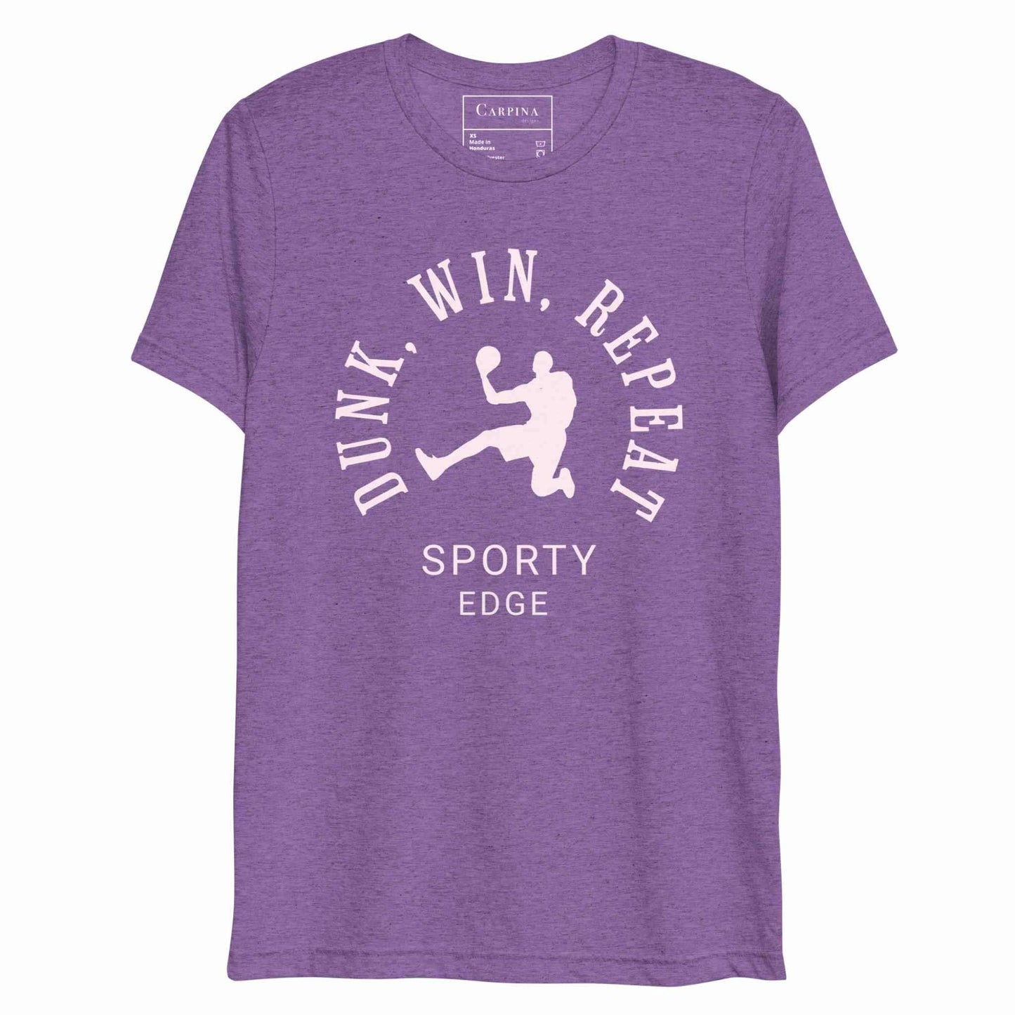 Flatlay of a basketball graphic tshirt in purple color.he unisex triblend tshirt features the words "Dunk, Win, Repeat and Sporty Edge" circling a graphic of an active basketball player. White background.