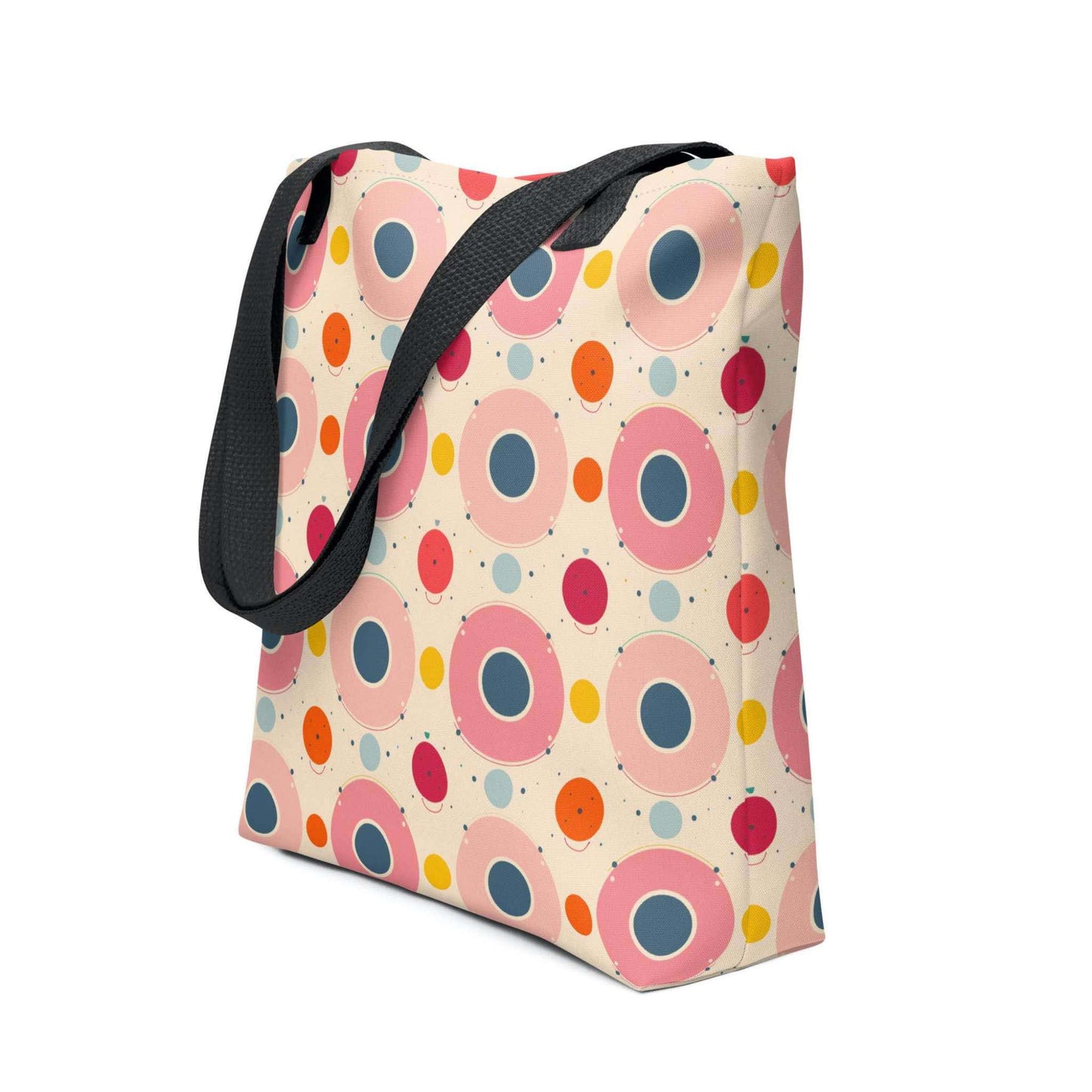Artsy tote bag with black handles, which features an artsy design of pastel candy pops of color in a beige background, shown in side view. Dimension 15x15 inches. White background.