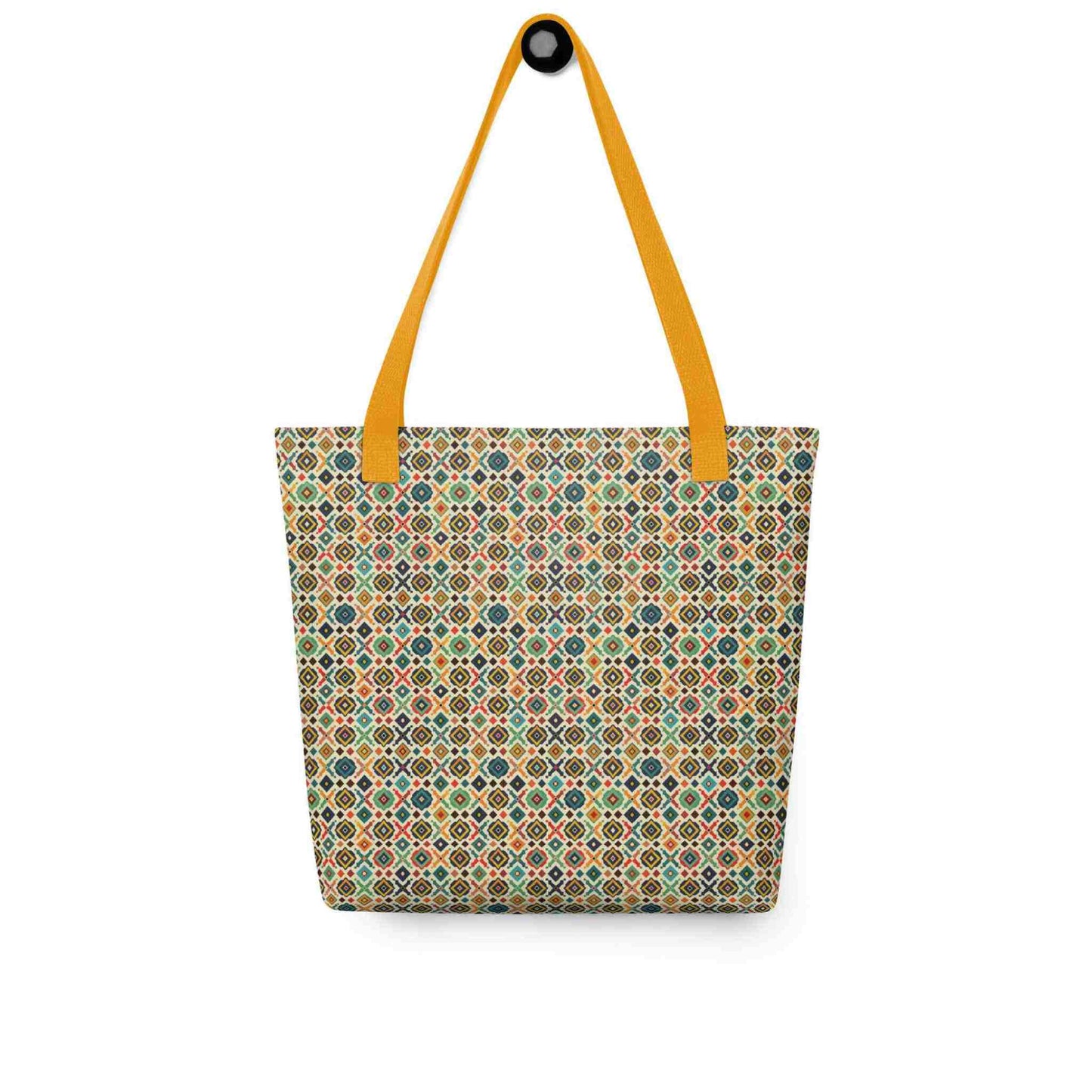 A 15x15 inch tote bag with yellow handles, which design is an Argentine inspired diamond pattern, hanging on a wall. White background.