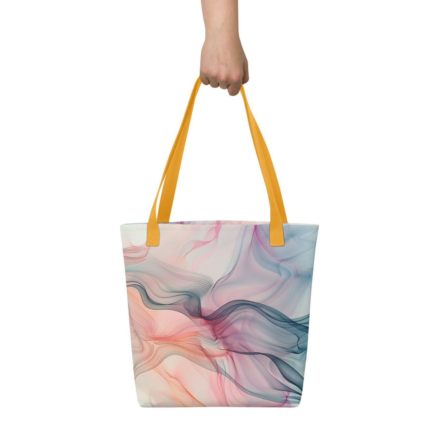 Fashion ladies tote bag with yellow handles, which design features an abstract art of artistic wavy bluish and pastel lines, held in a hand against a white wall. Dimension 15x15 inches.