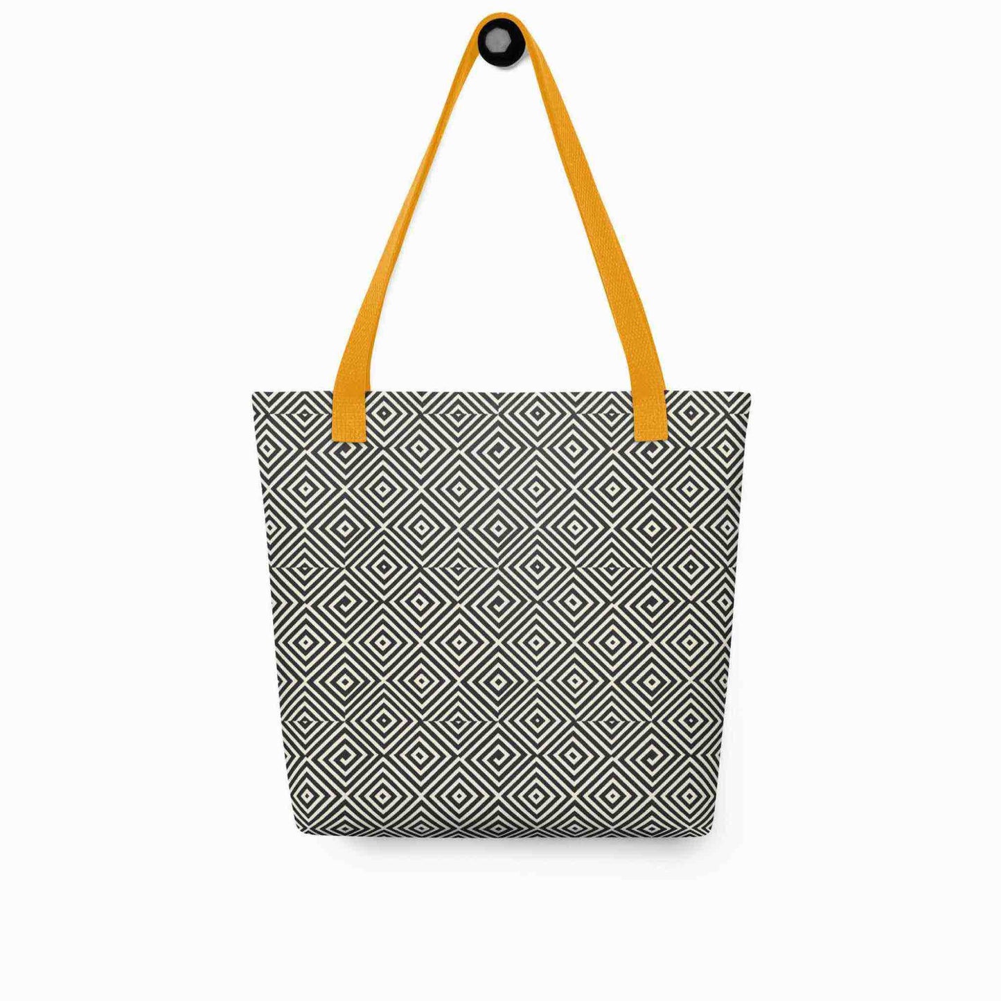A diamond pattern tote bag with yellow handles, which features a mesmerizing black and white geometric look, hanging on a white wall.