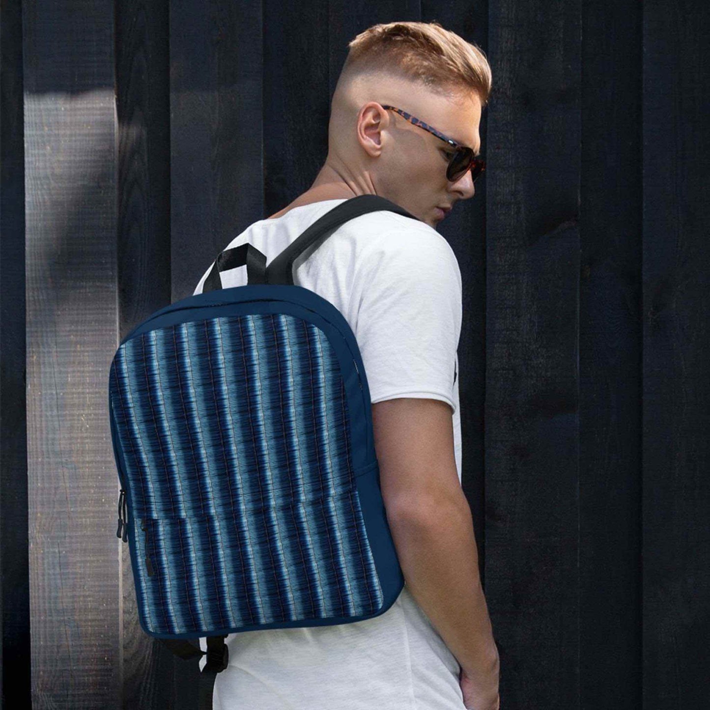 Caucasian man with denim stripe backpack.