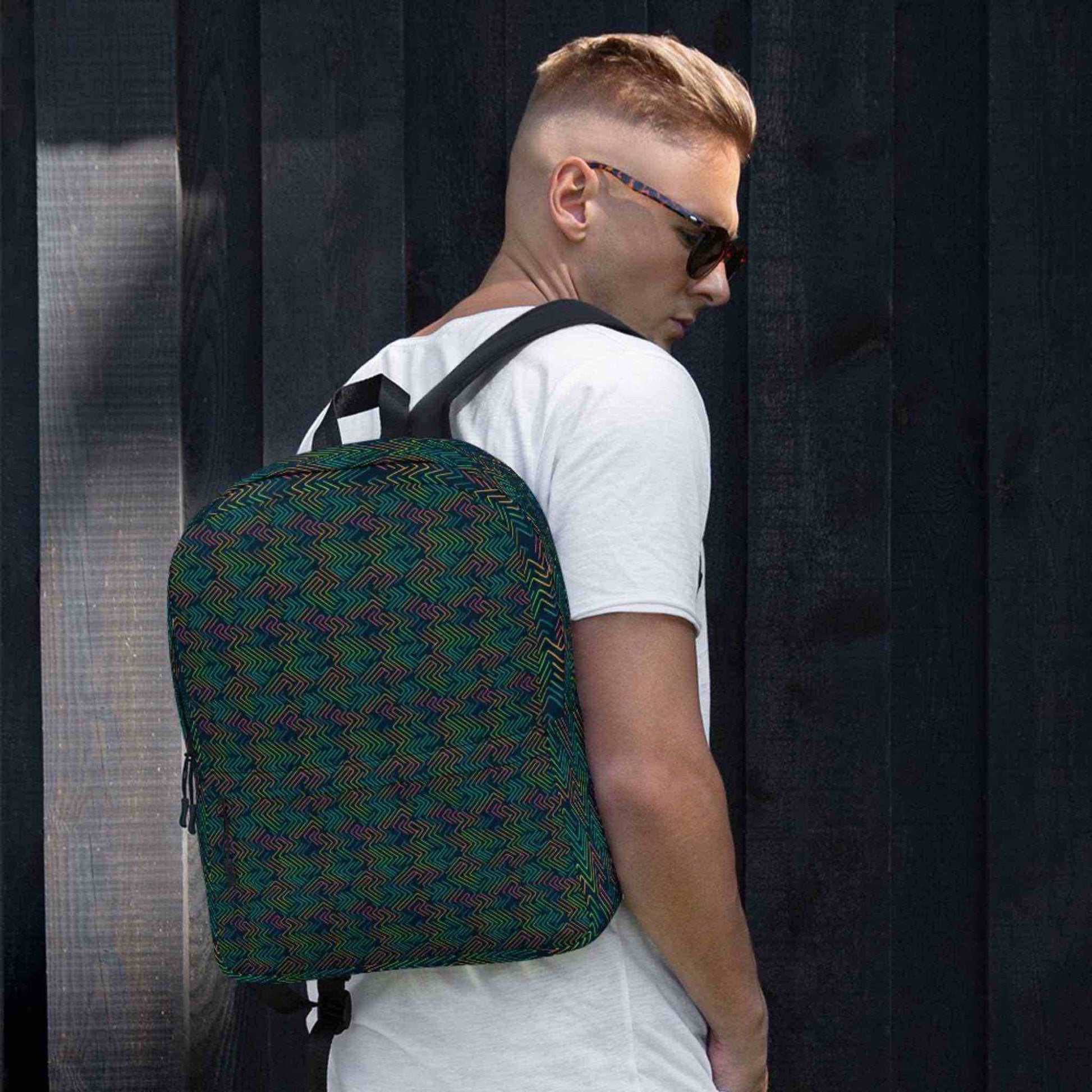 Caucasian man with backpack with dark neon pattern akin to electric circuits. Style is athletic and urbane.