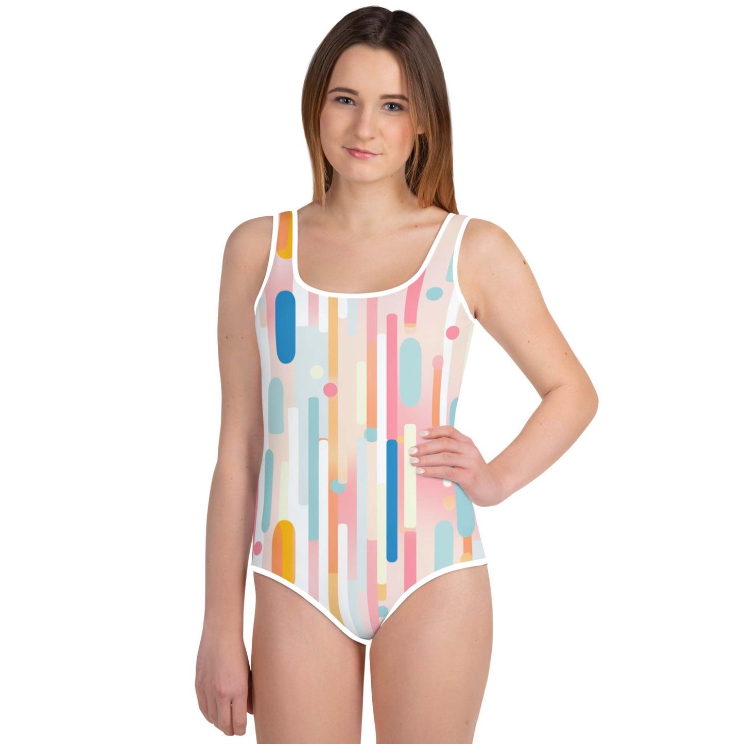 Front view of young girl in a light candy coloured one-piece swimsuit, against a white background.