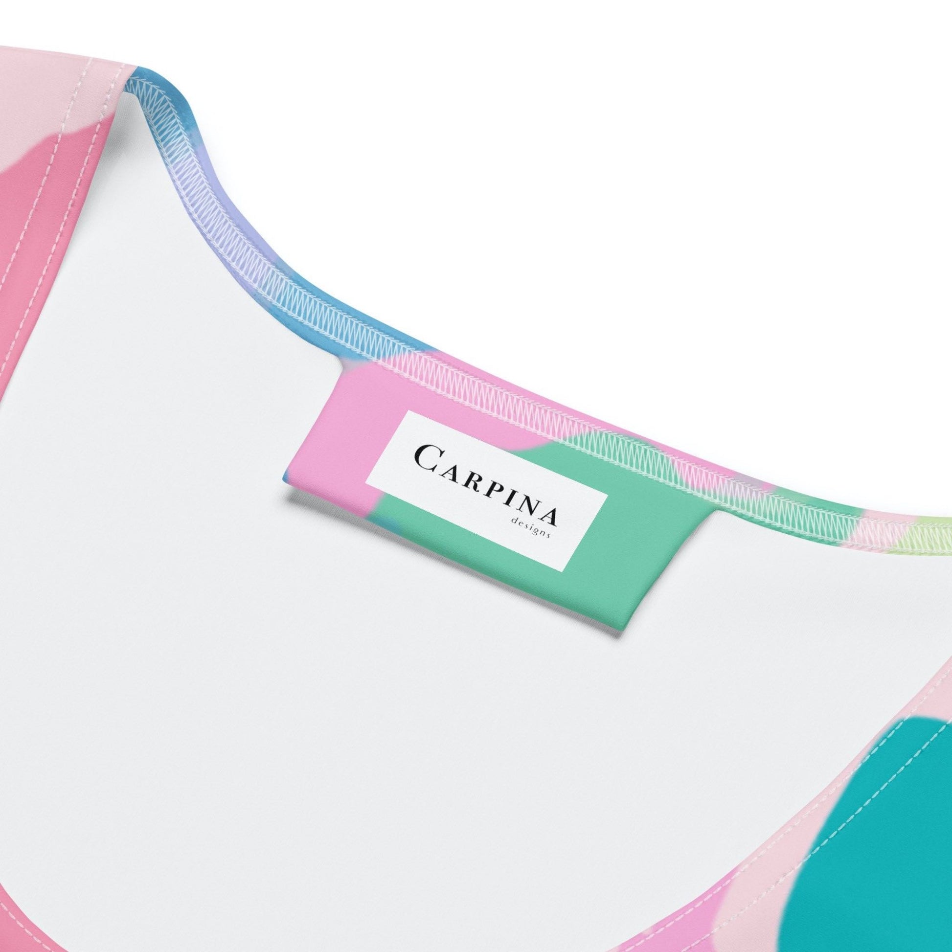 Inside label of a dress, displaying the brand name, "Carpina Designs"