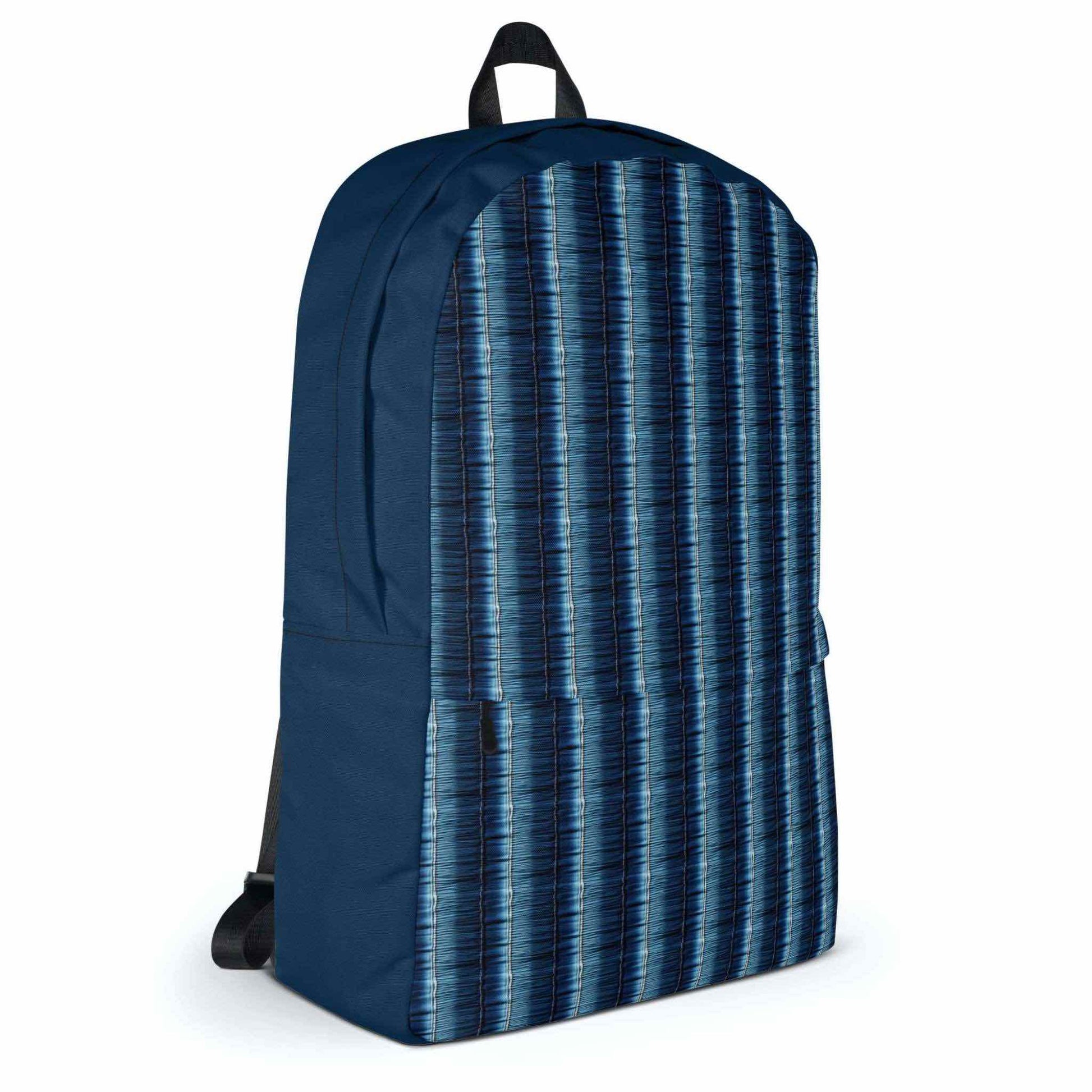 Printed backpack featuring denim stripes shown in a frontal left view. Sides of backpack are in solid dark blue fabric.