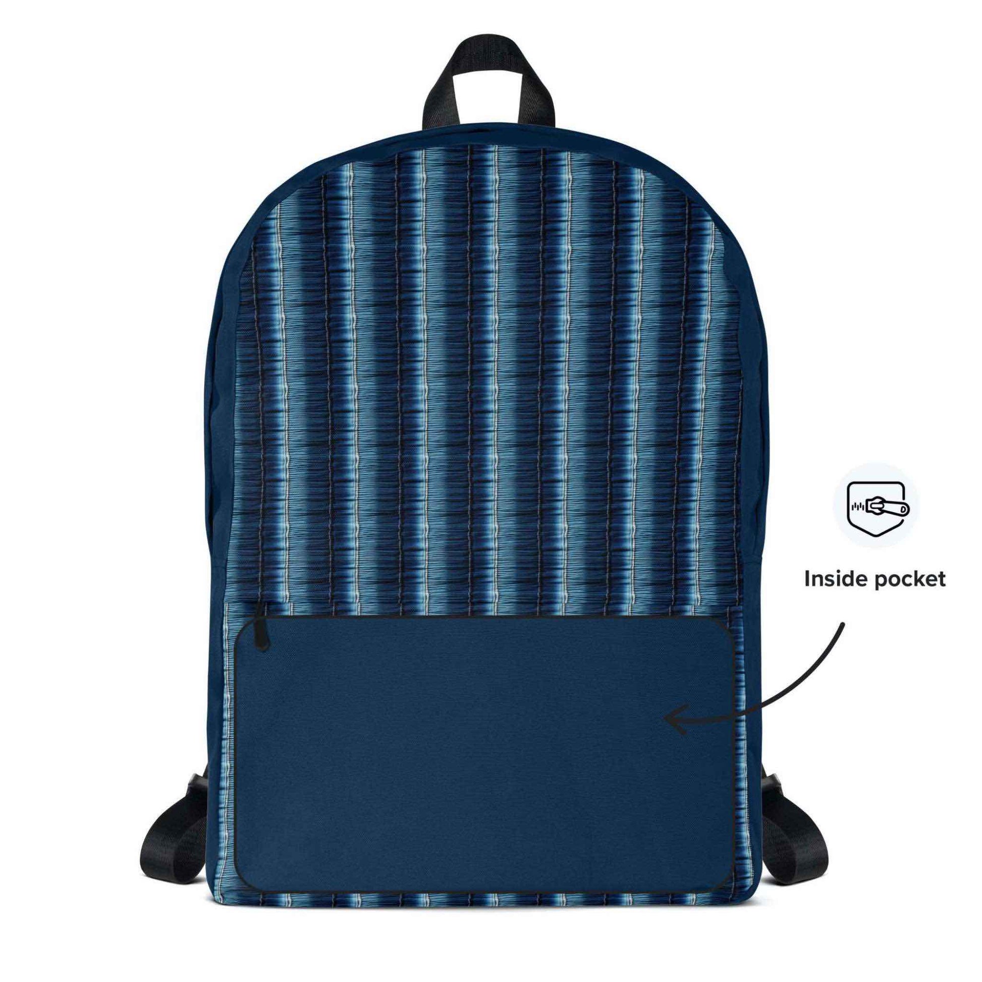 Printed backpack featuring denim stripes shown in a frontal view, the solid dark blue  fabric of the inside of the front pocket exposted.
