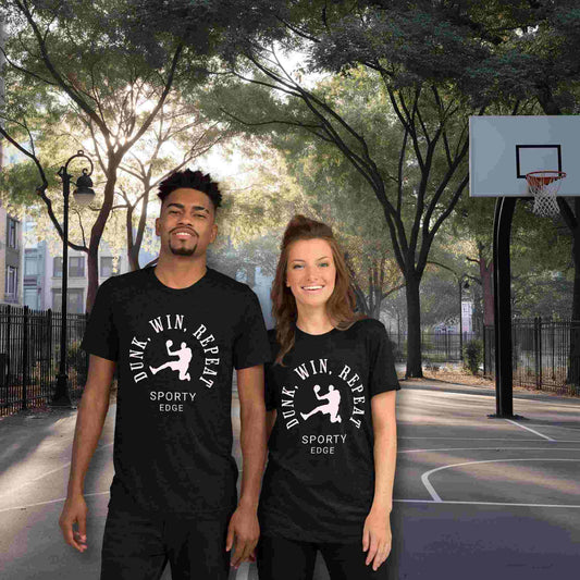 Basketball graphic tshirts in solid black color won by a couple standing on a basketball court. The unisex triblend tshirt features the words "Dunk, Win, Repeat and Sporty Edge" circling a graphic of an active basketball player.
