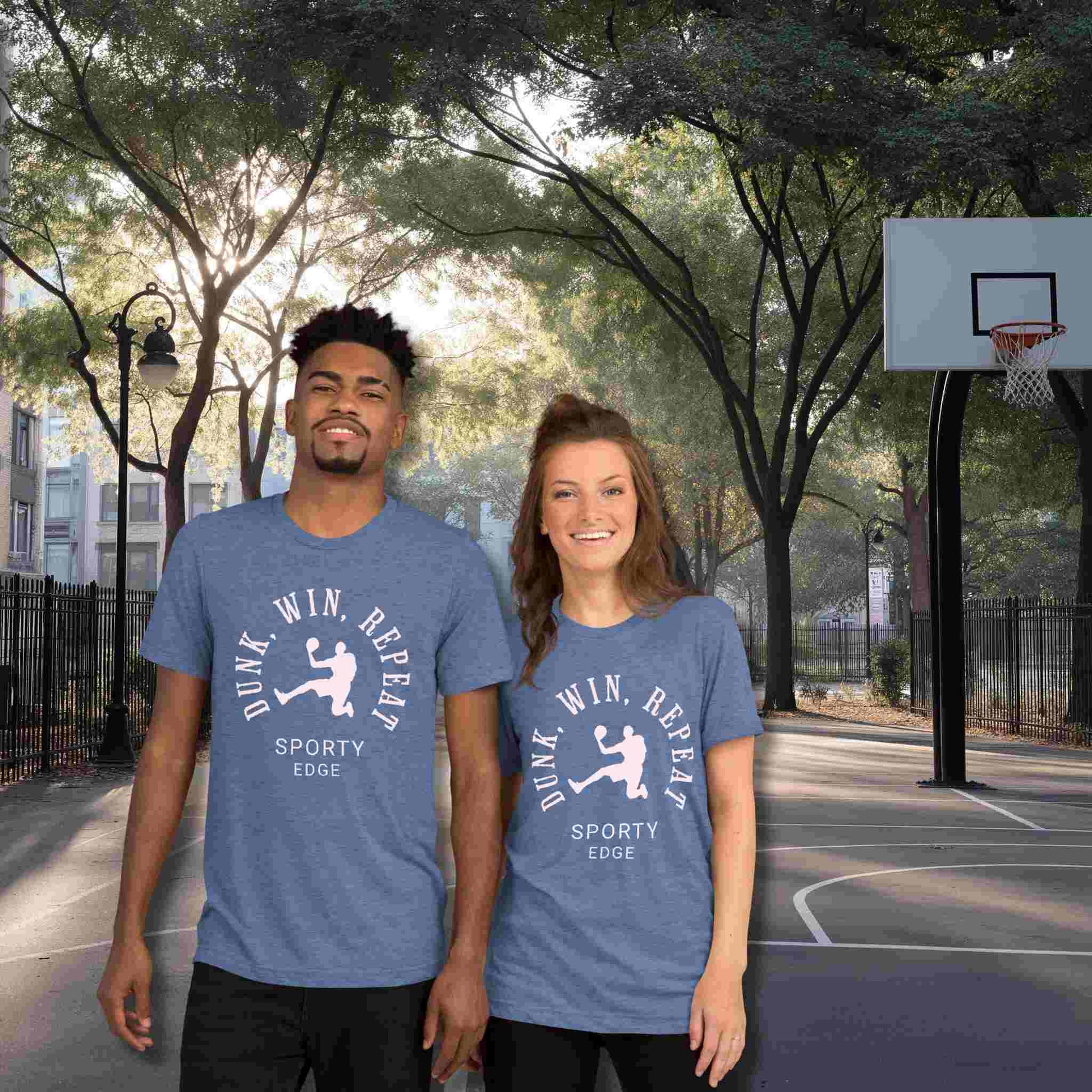 Basketball graphic tshirts in blue color won by a couple standing on a basketball court. The unisex triblend tshirt features the words "Dunk, Win, Repeat and Sporty Edge" circling a graphic of an active basketball player.