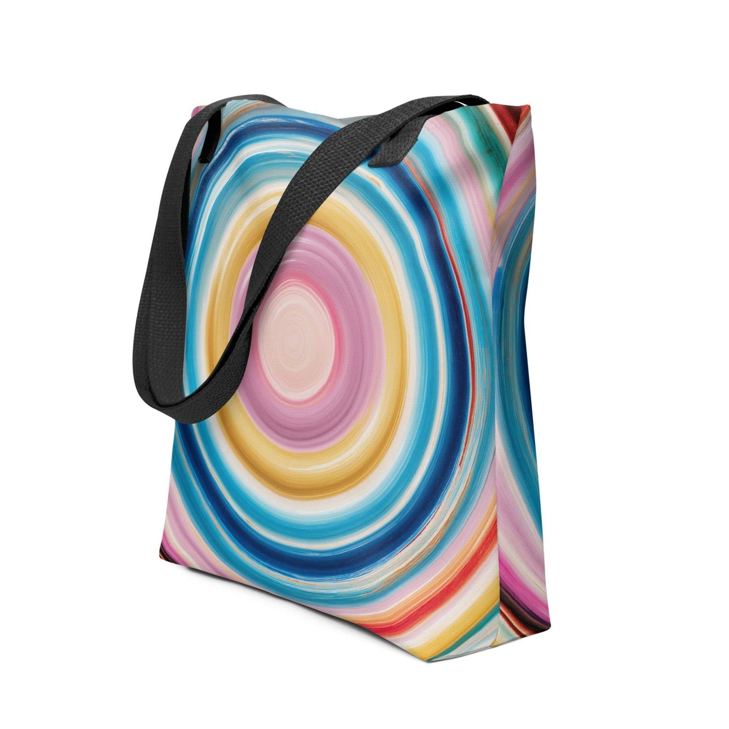 Colorful tote bag which features a mesmerizing abstract design of strong, hypnotic color circles, with black handles. Dimension 15x15 inches, polyester. Side view. White blackground. 