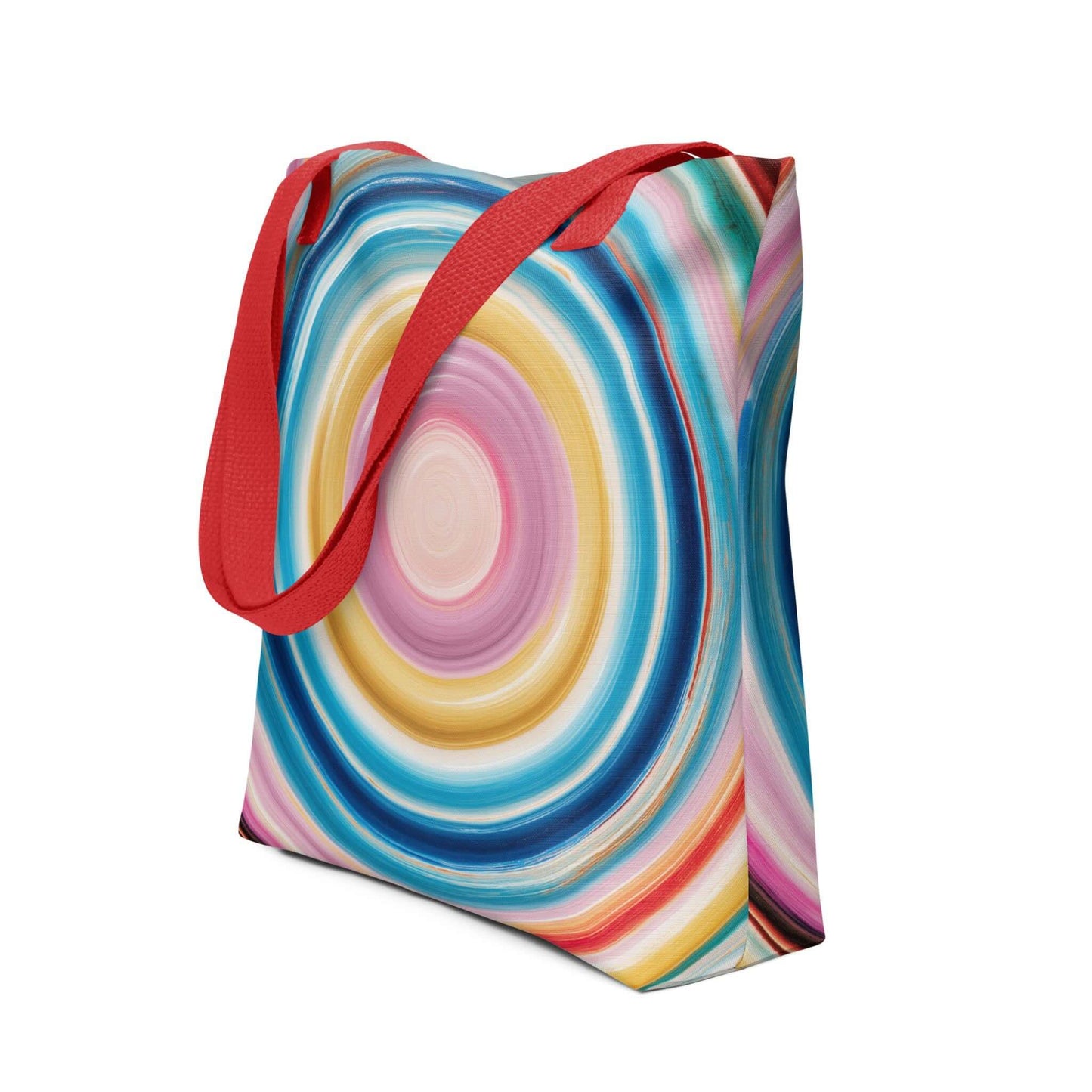 Colorful tote bag which features a mesmerizing abstract design of strong, hypnotic color circles, with red handles. Dimension 15x15 inches, polyester. Side view. White blackground. 