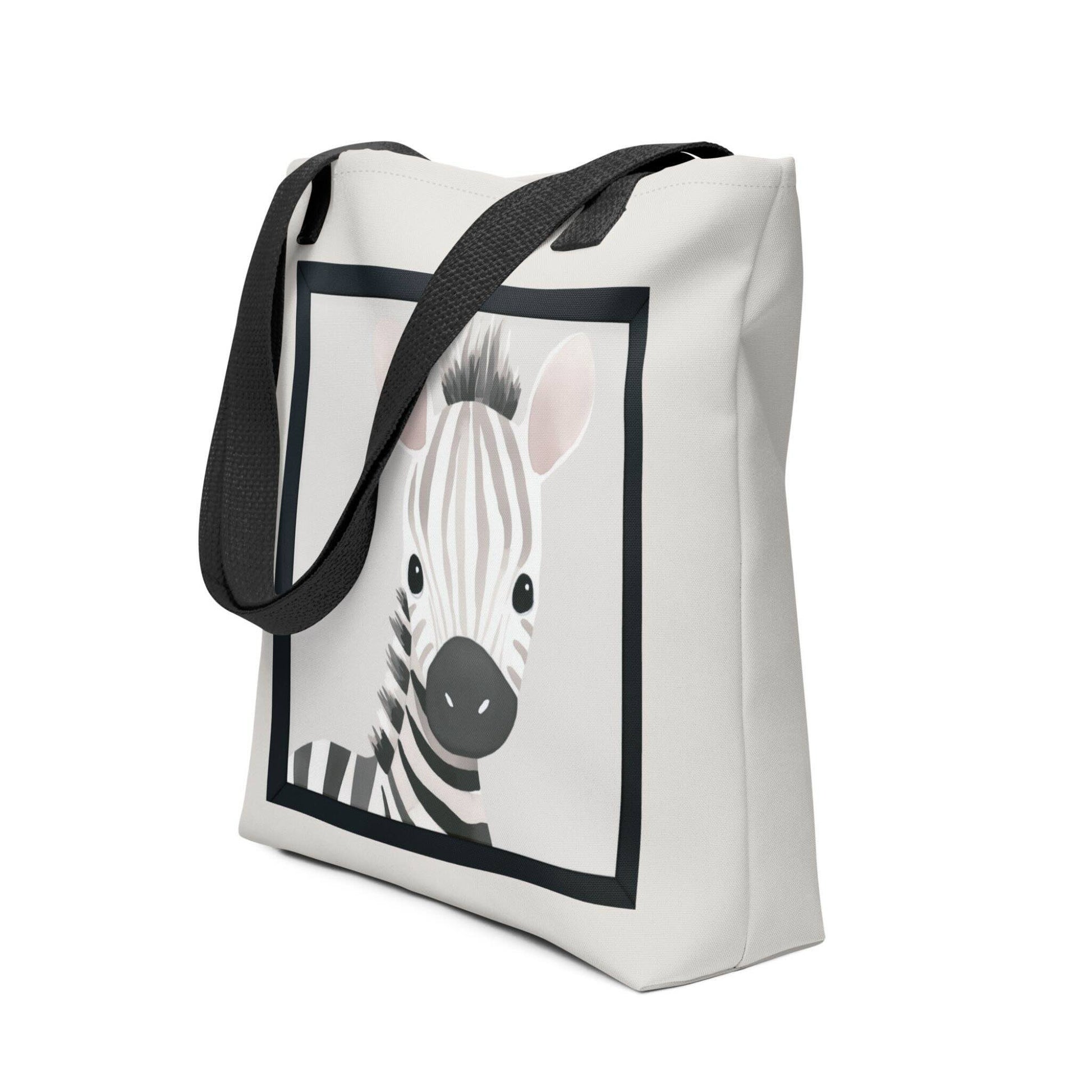 Cute totes with watercolor illustration that captures the sweet, gentle innocence of a baby zebra with soft taupe and cream stripes, topped with an irresistibly spiky mane. Black handles. Dimensions 15x15 inches. Side view. White background.