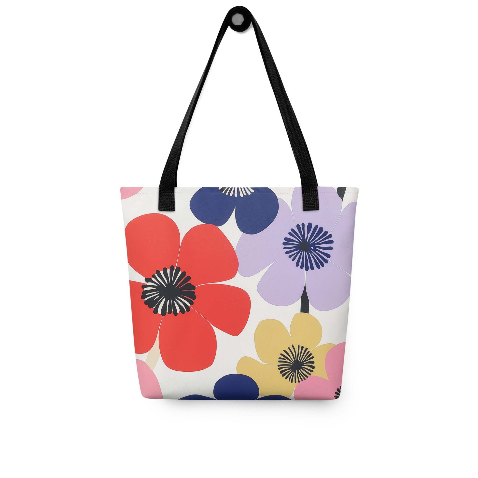 A Floral Tote Bag, with black handles, which features a stunning, abstract bloom pattern that brings warmth and joy wherever you go.The bag hangs on a wall. White background.
