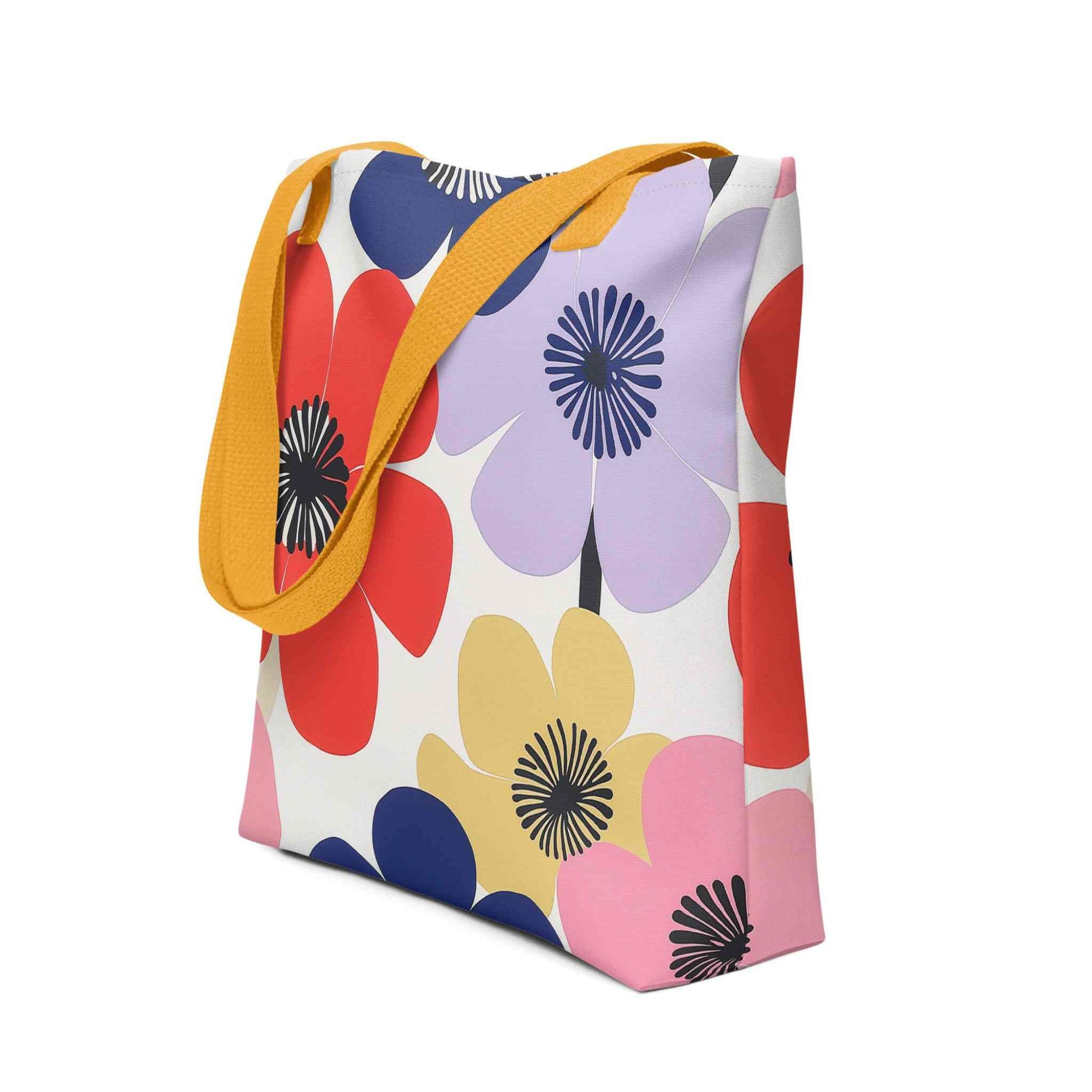 A Floral Tote Bag, with yellow handles, which features a stunning, abstract bloom pattern that brings warmth and joy wherever you go. Side View. White background.