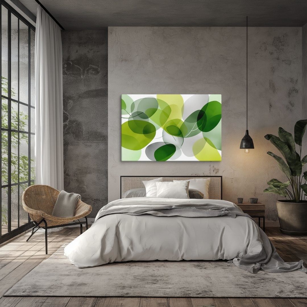 Illustration of a modern botanical artwork features layered, translucent green and chartreuse organic shapes for a lush, sophisticated feel on canvas, hanging in bedroom over a bed. 