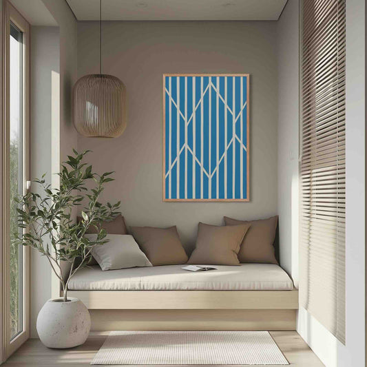 Illustration 1 of a compelling piece of blue and white abstract art, OBLIQUE, in framed poster. This sophisticated design creates visual drama as static vertical stripes are dynamically intersected by bold, angular white lines. The result is a striking, kinetic composition perfect for modern interiors. The framed poster hangs in a contemporary reading room.