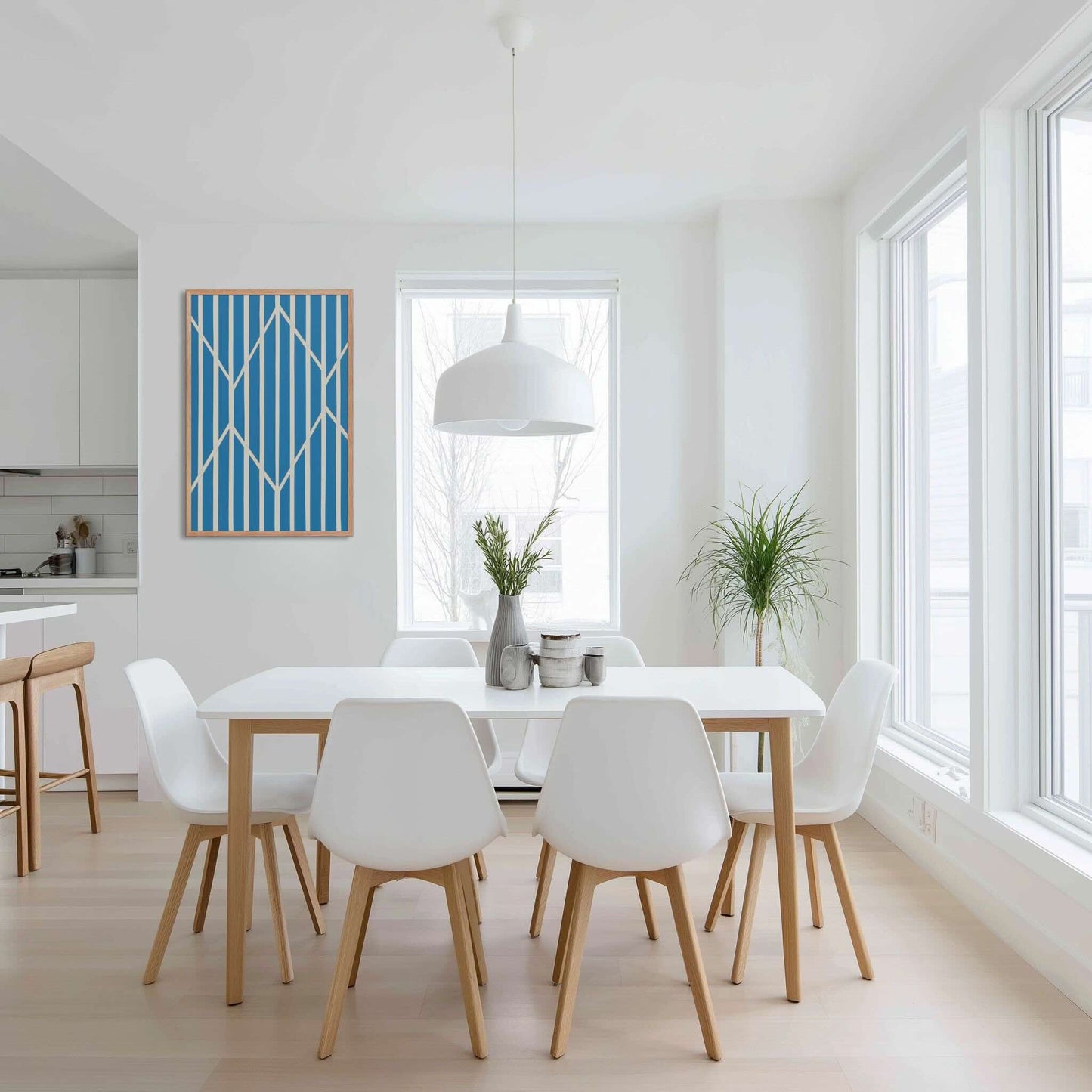 Illustration 4 of a compelling piece of blue and white abstract art, OBLIQUE, in framed poster. This sophisticated design creates visual drama as static vertical stripes are dynamically intersected by bold, angular white lines. The result is a striking, kinetic composition perfect for modern interiors. The framed poster hangs on white wall in a contemporary dining area.