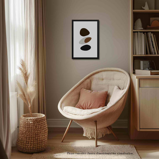 Framed abstract art organic form in a blend of modern minimalism and organic shapes in neutral colors. Framed in black wood. The wall art hangs on a beige wall above a beige chair n a cosy room furnished in beige.