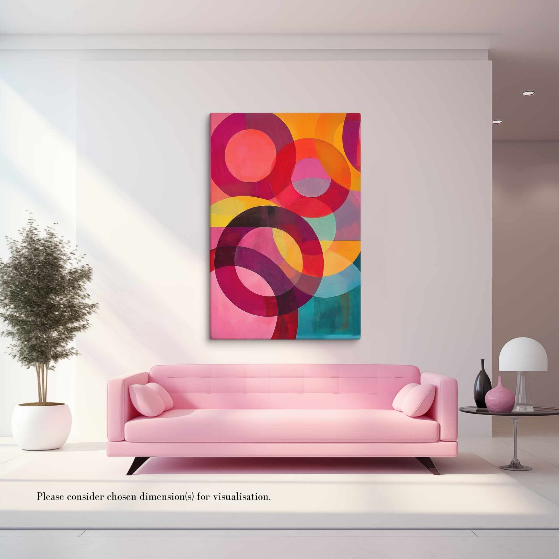 A captivating circular abstract painting featuring vivid reds, pinks, oranges, teal and gold, hung on a white wall in a modern white living, above a clean-cut pink sofa.