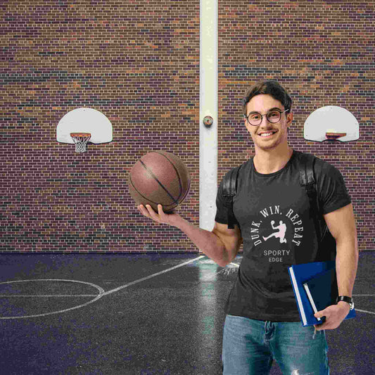 Student in black triblend basketball graphic t-shirt holding a basketball.