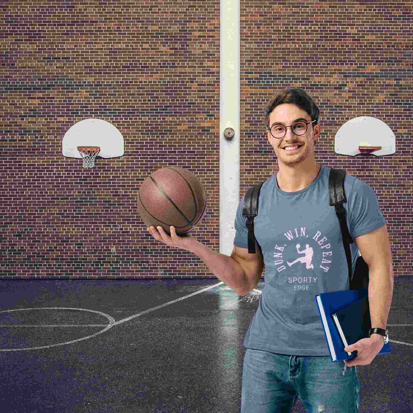 Student in blue triblend basketball graphic t-shirt holding a basketball.