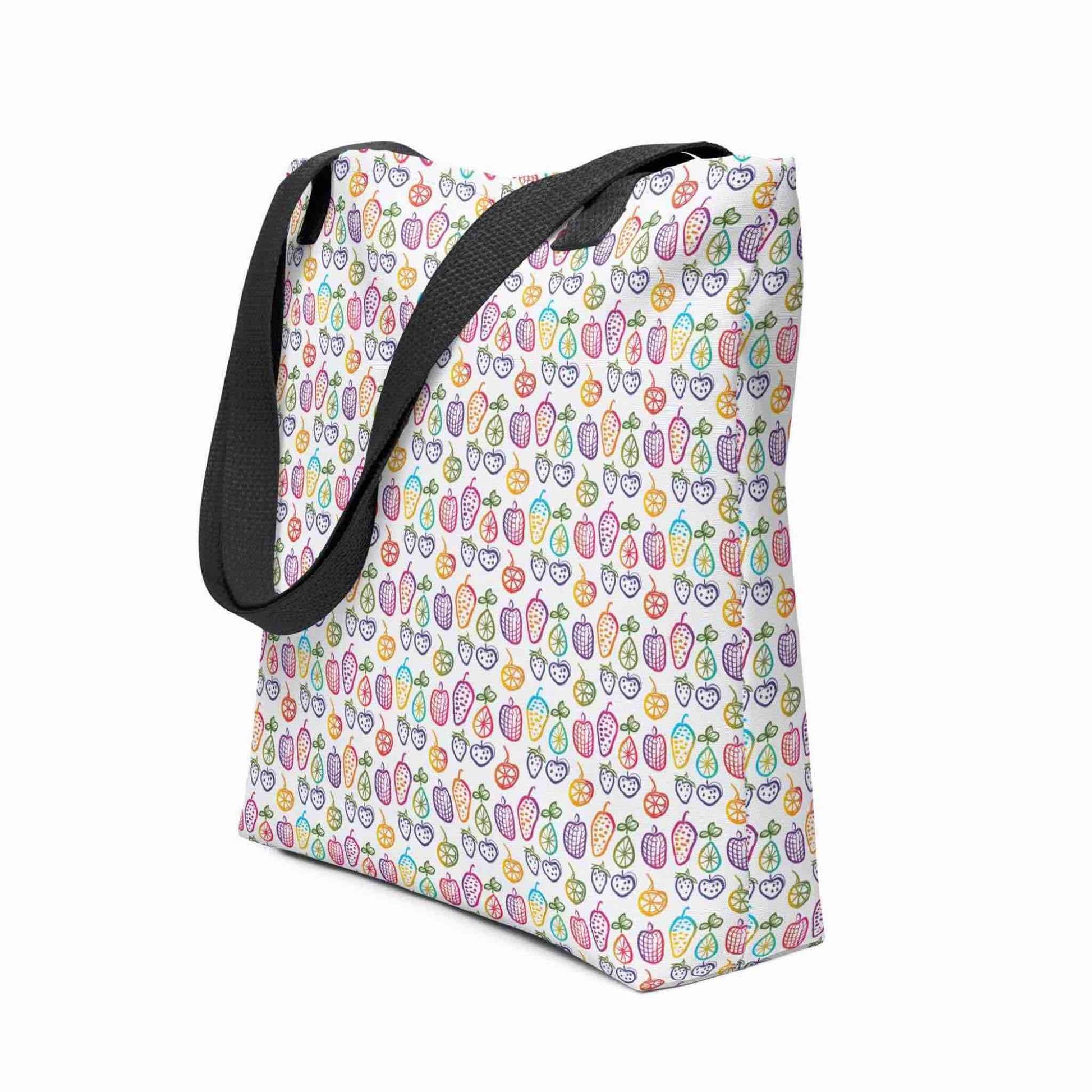 A fruit tote bag with black handles, which features a colourful cheerful doodles of fruits in a crisp white background, shown in side view. Dimension 15x15 inches. White background.