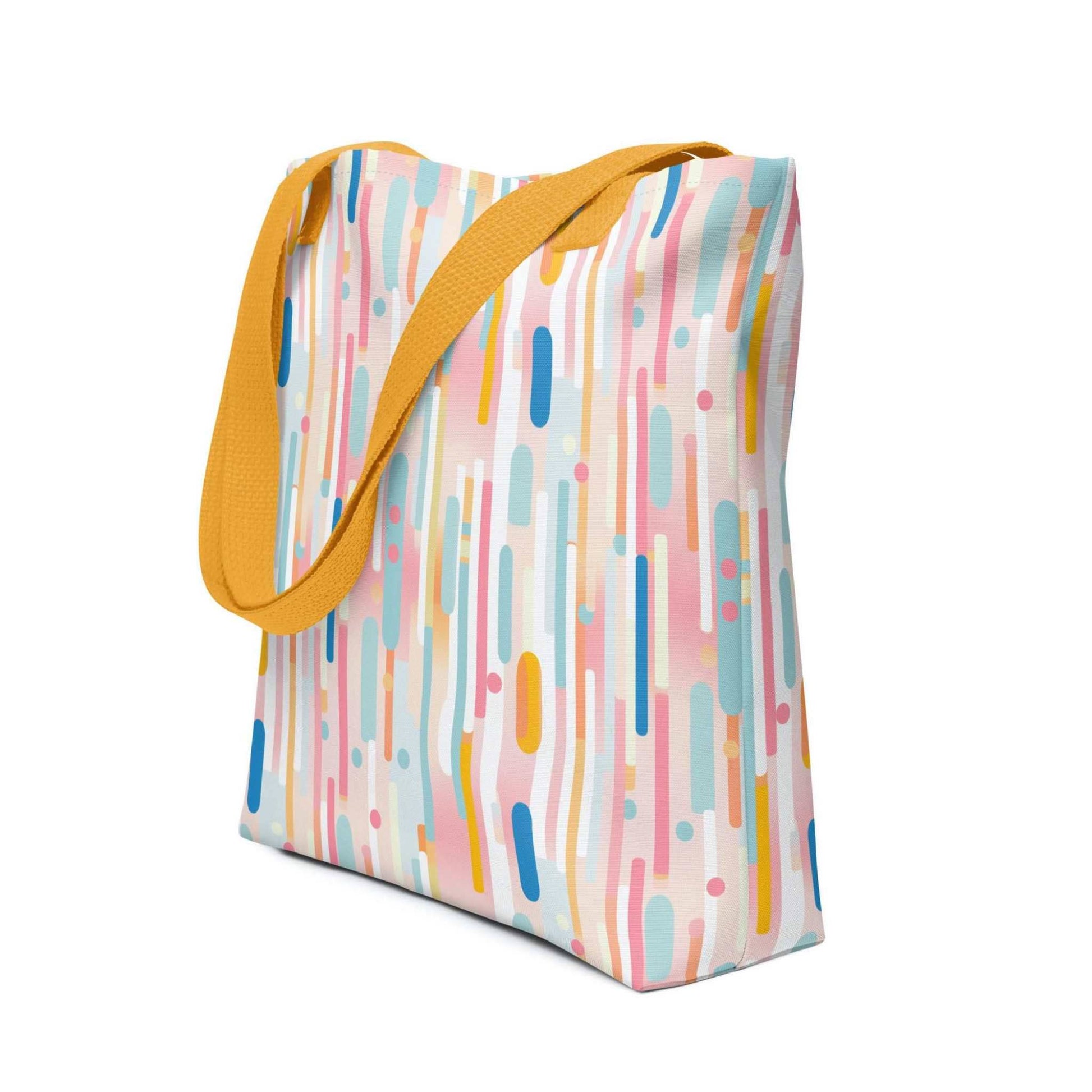 Light pink tote bag with yellow handles, which design is abstract vertical lines of pastel pink and other pastel shades, shown in side view. Dimension 15x15 inches. White background.
