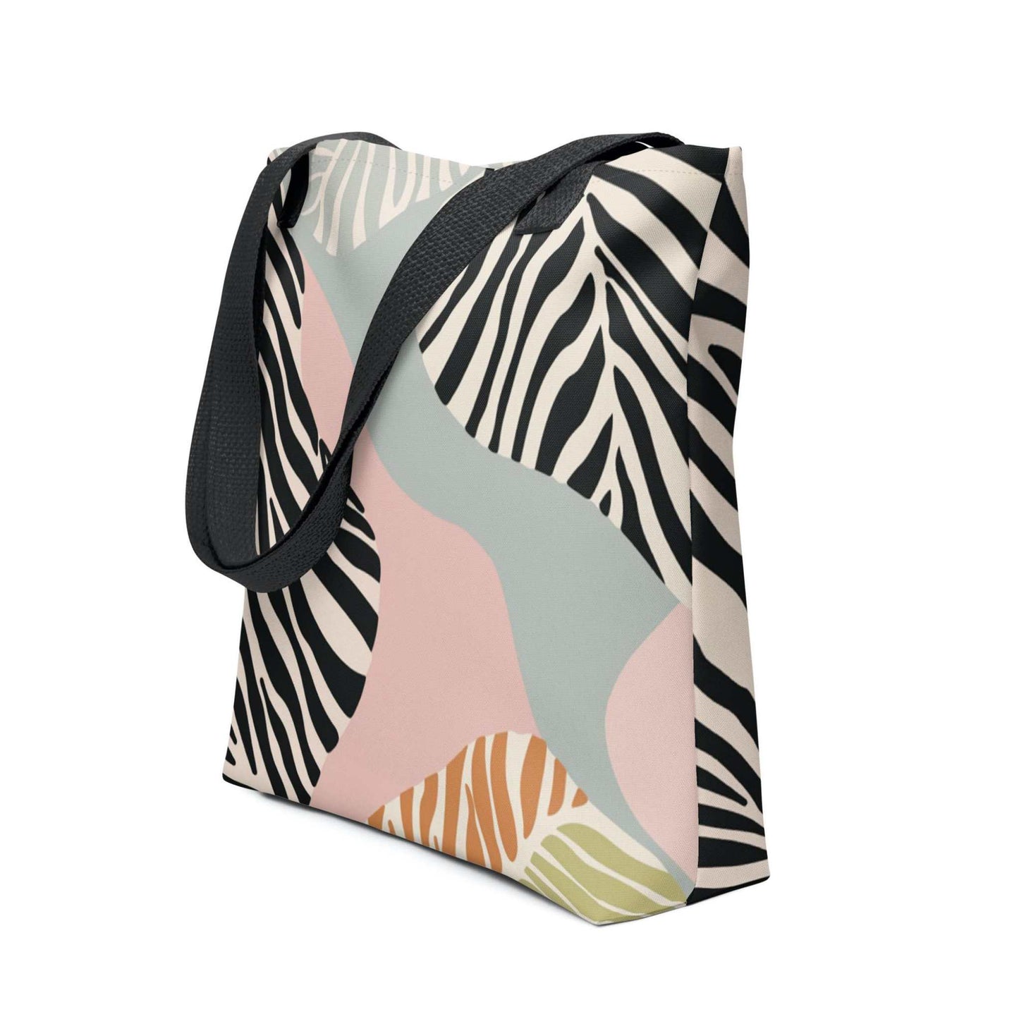 Side view of a 15x15 inch tote bag with black handles, in a colourful Zebra inspired design. White background.