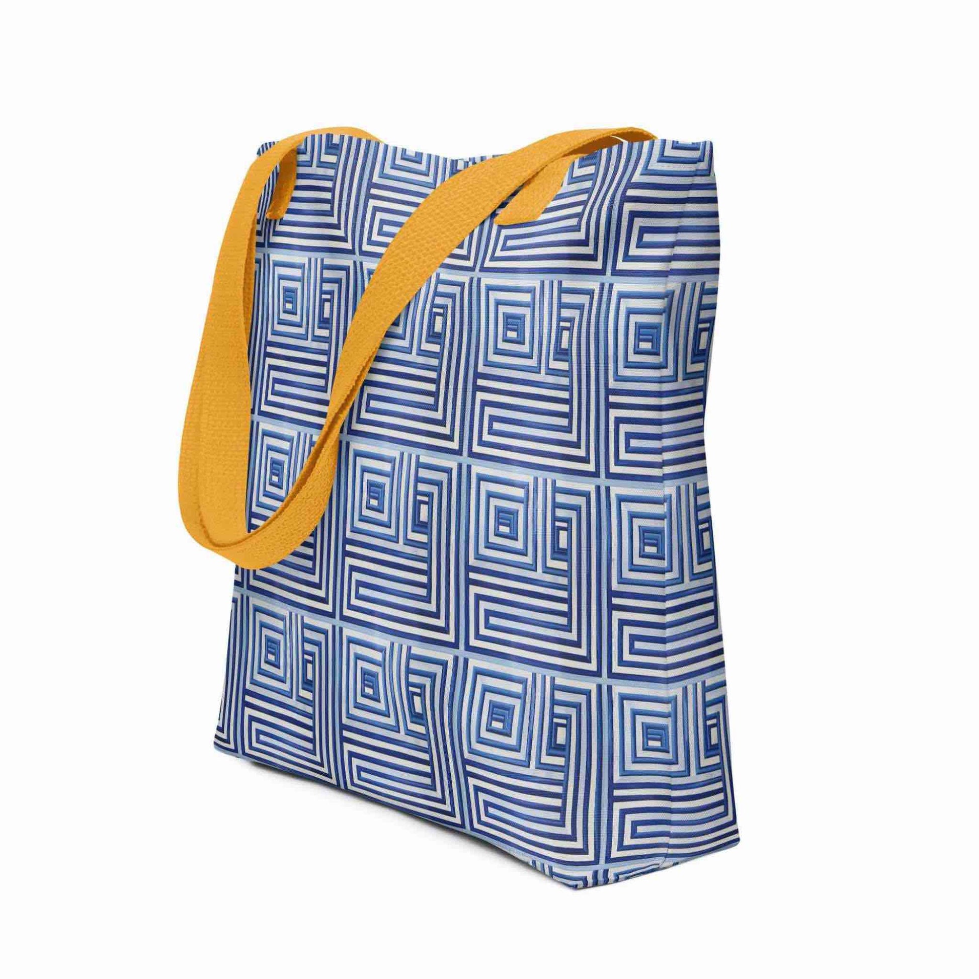 Side view of a 15x15 inch tote bag with yellow handles, which features a blue op art illusion on a white background. White background