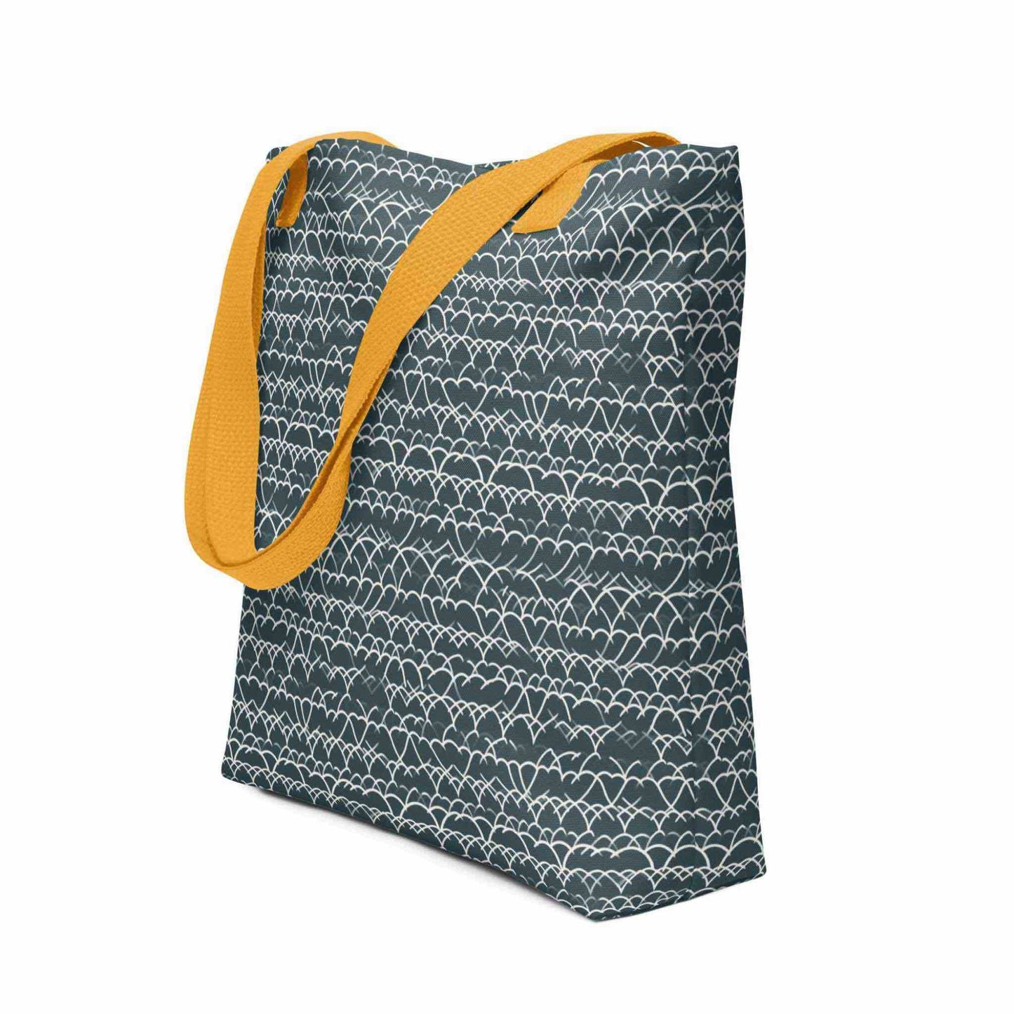 Side view of a 15x15 inch tote bag with yellow handles, which features a white geometric lace design that dances across a blue background. White background.