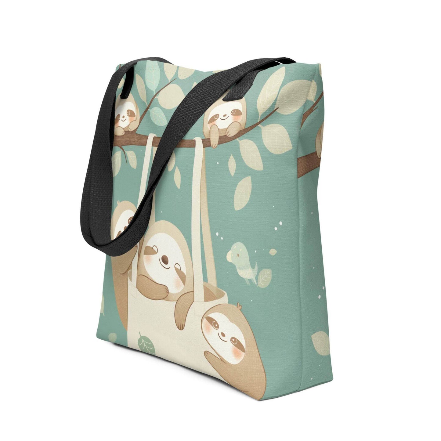 The cutest sloth tote bag you'll ever carry! This charming, sophisticated design captures the tranquility of the forest, with black shoulder handles. Side view. White background.