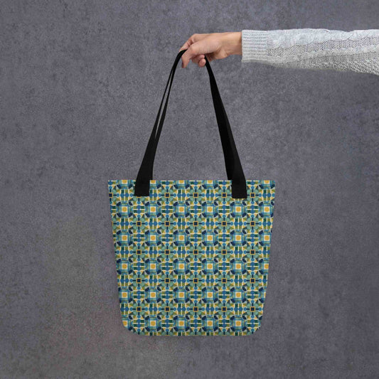 Elevate your style with the TILEWAVE Abstract Tote Bag, featuring a vibrant geometric tile pattern in modern retro hues. Perfect for daily essentials, this 15" x 15" polyester tote bag combines playful structure with sophisticated charm. Black handle. Held in a hand. Grey background.