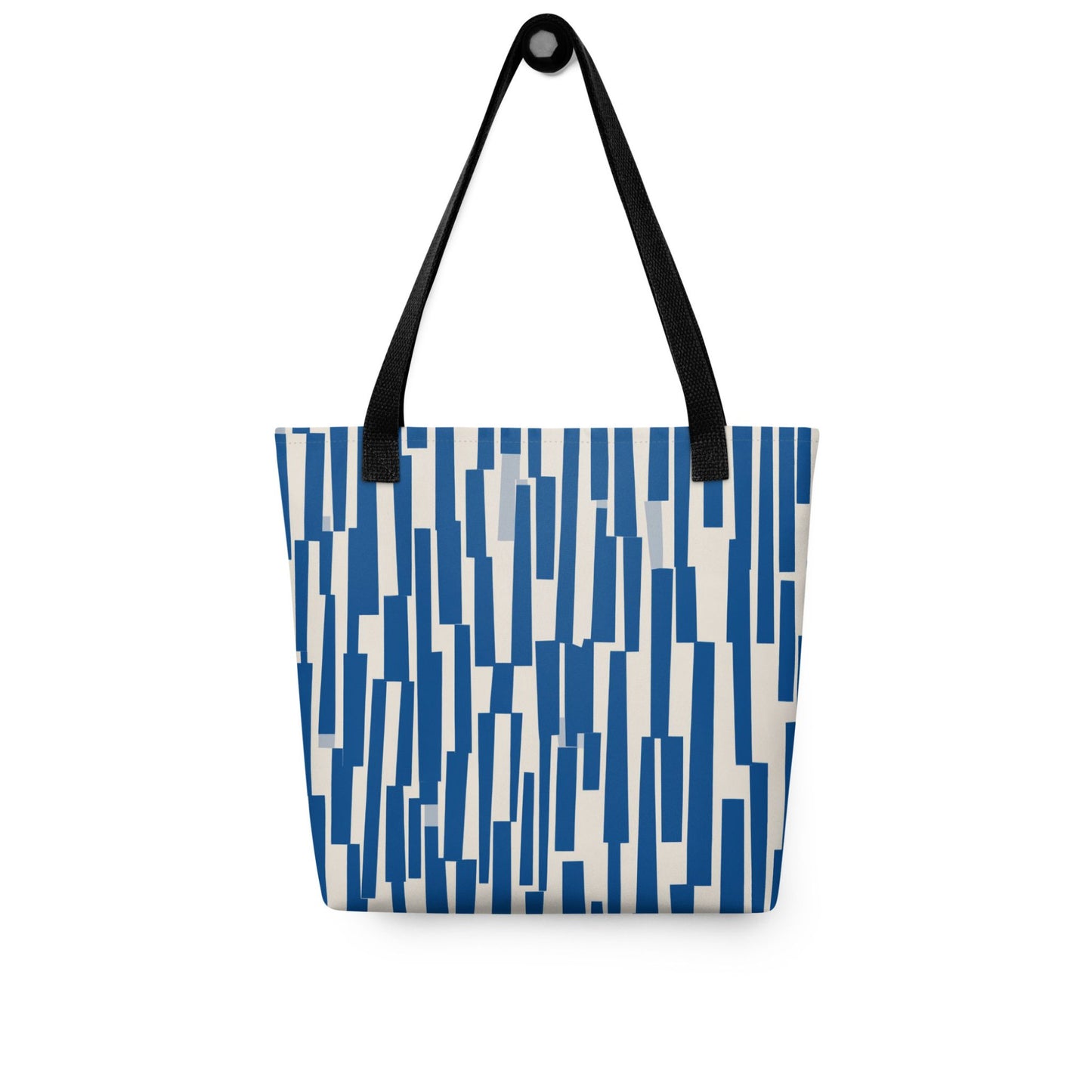 The tote bag blue, where rhythm meets charm. This abstract design features a chaotic yet charming cascade of navy shapes, resembling musical staccato notes played against a soft cream backdrop. Front view. White background.