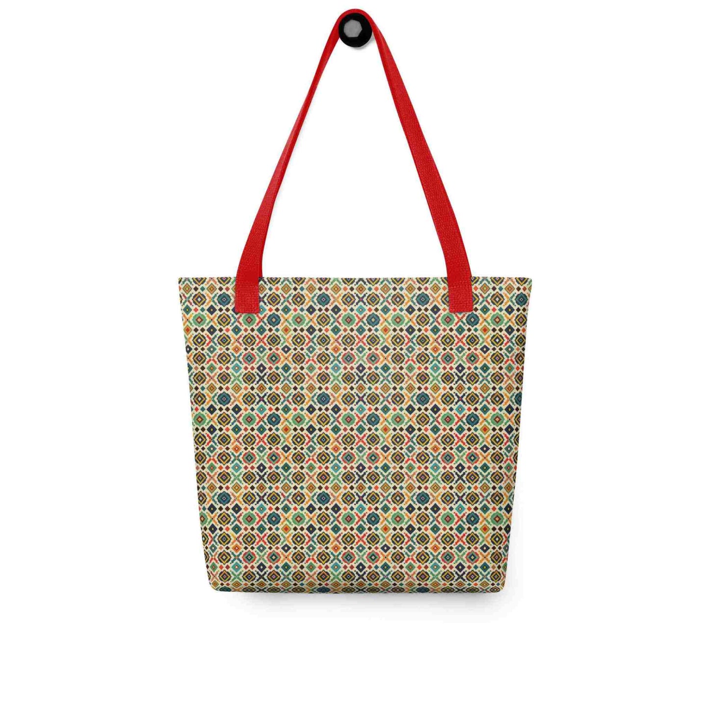 A 15x15 inch tote bag with red handles, which design is an Argentine inspired diamond pattern, hanging on a wall. White background.