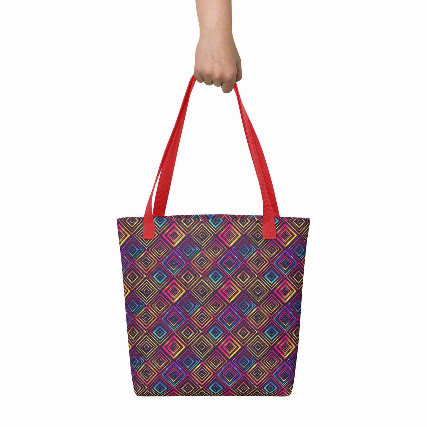 A 15x15 inch tote bag with red handles, which features a neon tapestry design in a sophisticated blend of colors, held by a hand. White background.