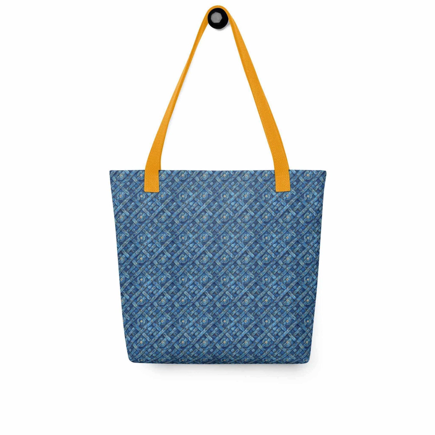 A 15x15 inch tote bag with yellow handles, which features a blue Viking inspired denim pattern, hanging on a wall hook. White background.