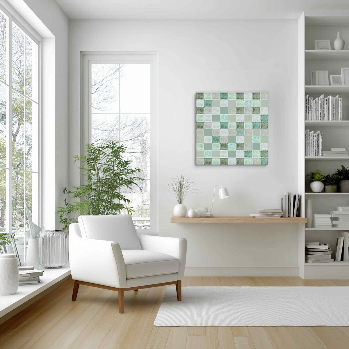 CELADON sage green abstract wall art canvas with layered mint, seafoam and forest green dotted squares, styled on a white wall in a bright Scandinavian reading corner with white armchair, tall window, indoor bamboo plant, floating oak shelf and white bookshelves, by Carpina Designs