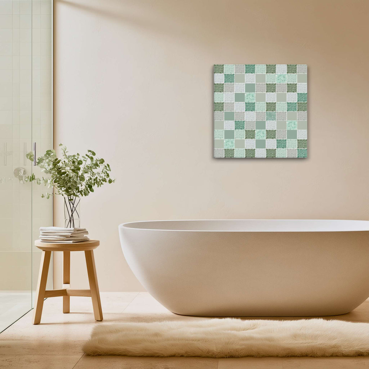 CELADON sage green abstract wall art canvas with dotted quilt pattern in mint, seafoam and forest greens, hanging above a freestanding oval bathtub in a spa-style bathroom with warm beige walls, wooden stool, eucalyptus stems, cream shaggy rug and frameless glass shower screen, by Carpina Designs