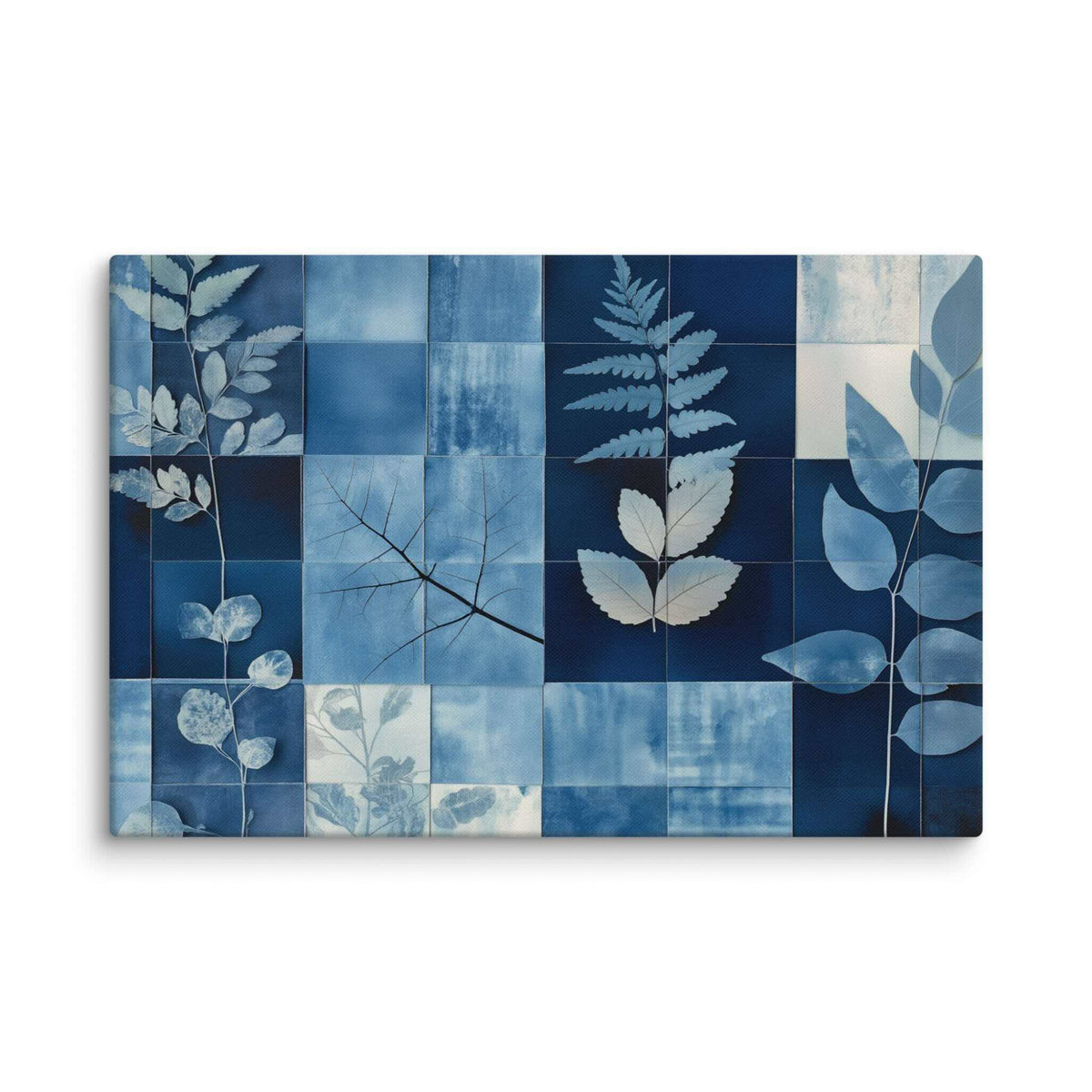 Cyanotype collage with white leaf silhouettes against rich indigo and navy blues in a modern grid, displayed as a 20 by 30 inch canvas print, PHOTOTYPE by Carpina Designs