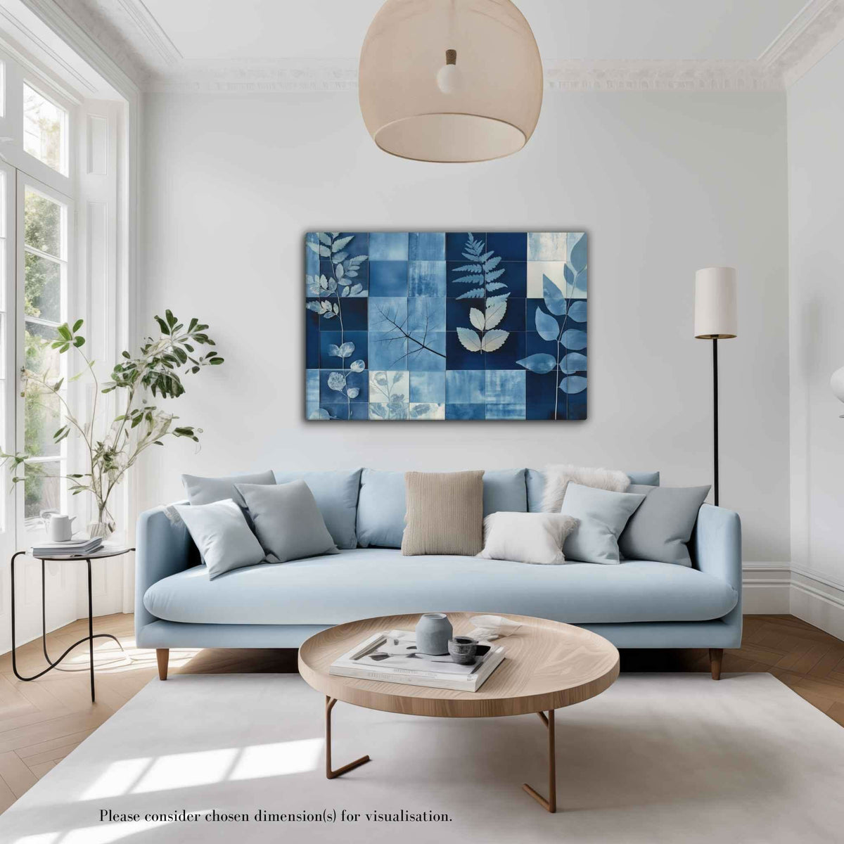 Cyanotype collage with white leaf silhouettes against rich indigo and navy blues in a modern grid, styled in a bright airy living room with light blue sofa and round wooden coffee table, PHOTOTYPE by Carpina Designs