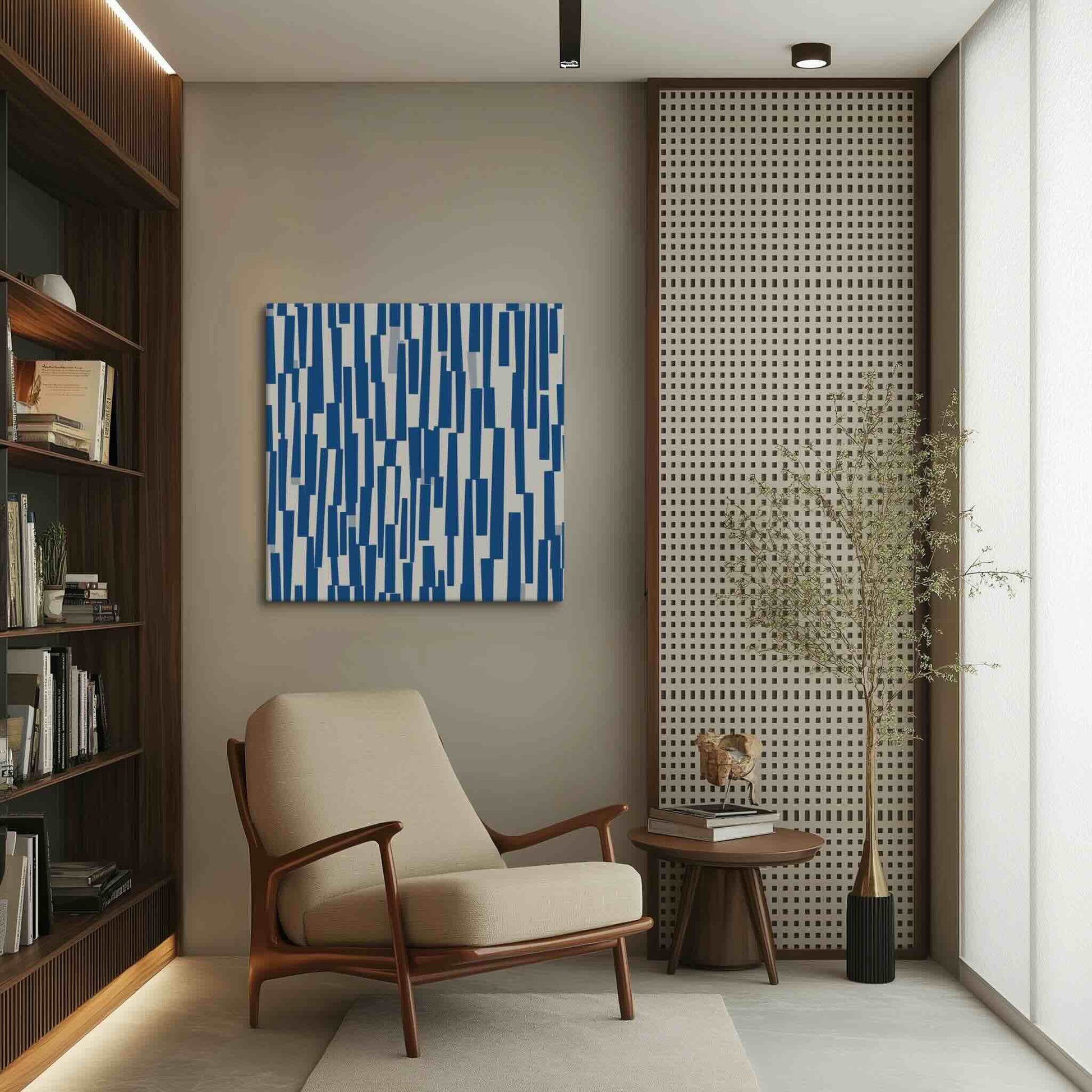 Blue and cream canvas art with rhythmic cascade of deep navy shapes against warm neutral backdrop of a beige neutral reading room with wood shelves, STACCATO by Carpina Designs