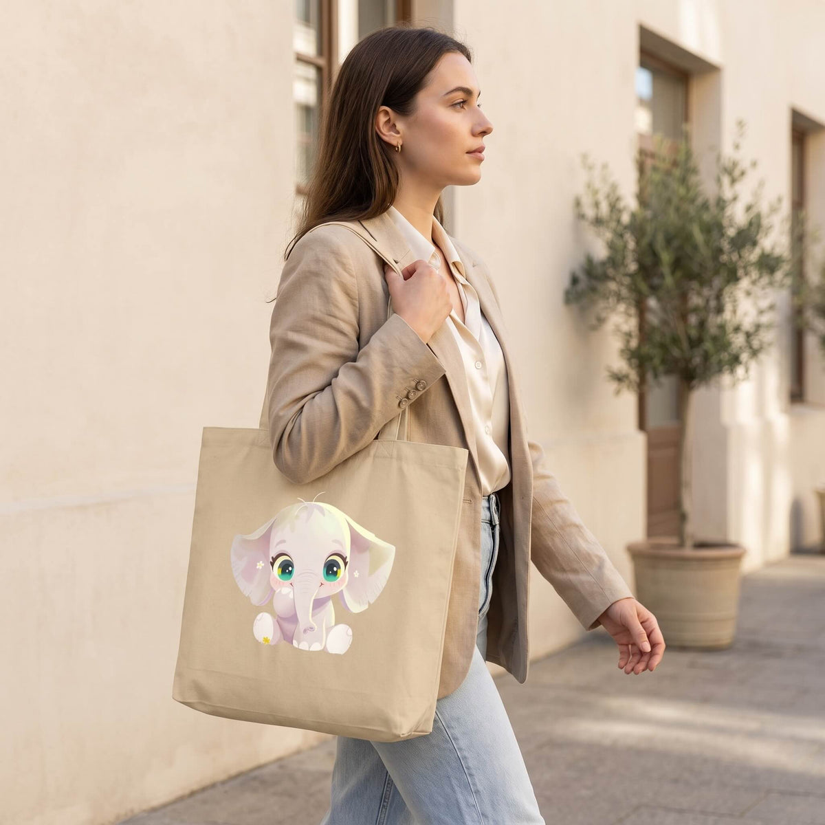 Side profile of a woman carrying SWEETPEA organic cotton elephant tote bag, sweet baby elephant print visible on the bag, double sided print on natural cotton, by Carpina Designs